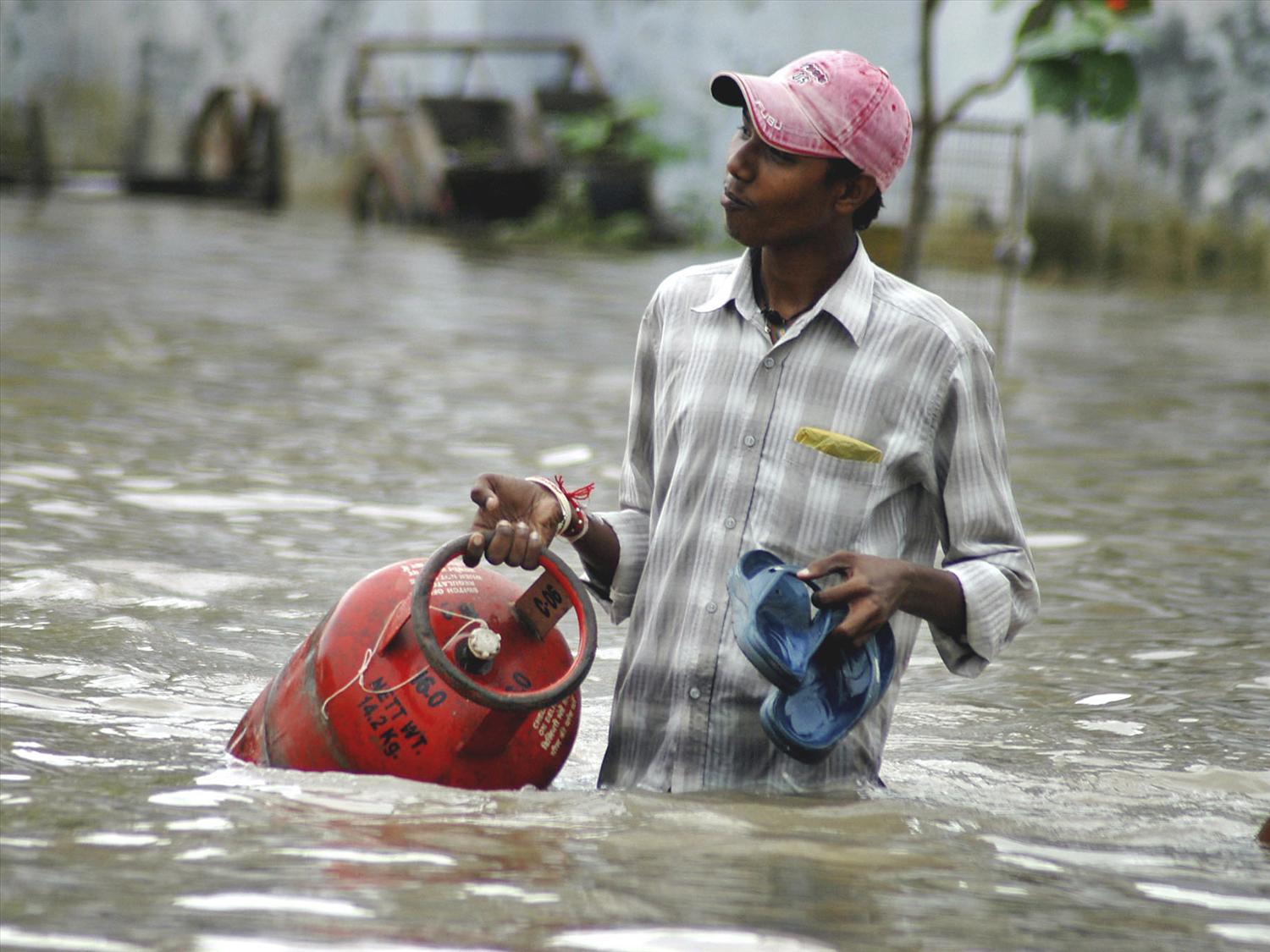 Man wades through flood waters, Vadodara, Gujarat state, India, photoMan wades through flood waters, Vadodara, Gujarat state, India, photo 