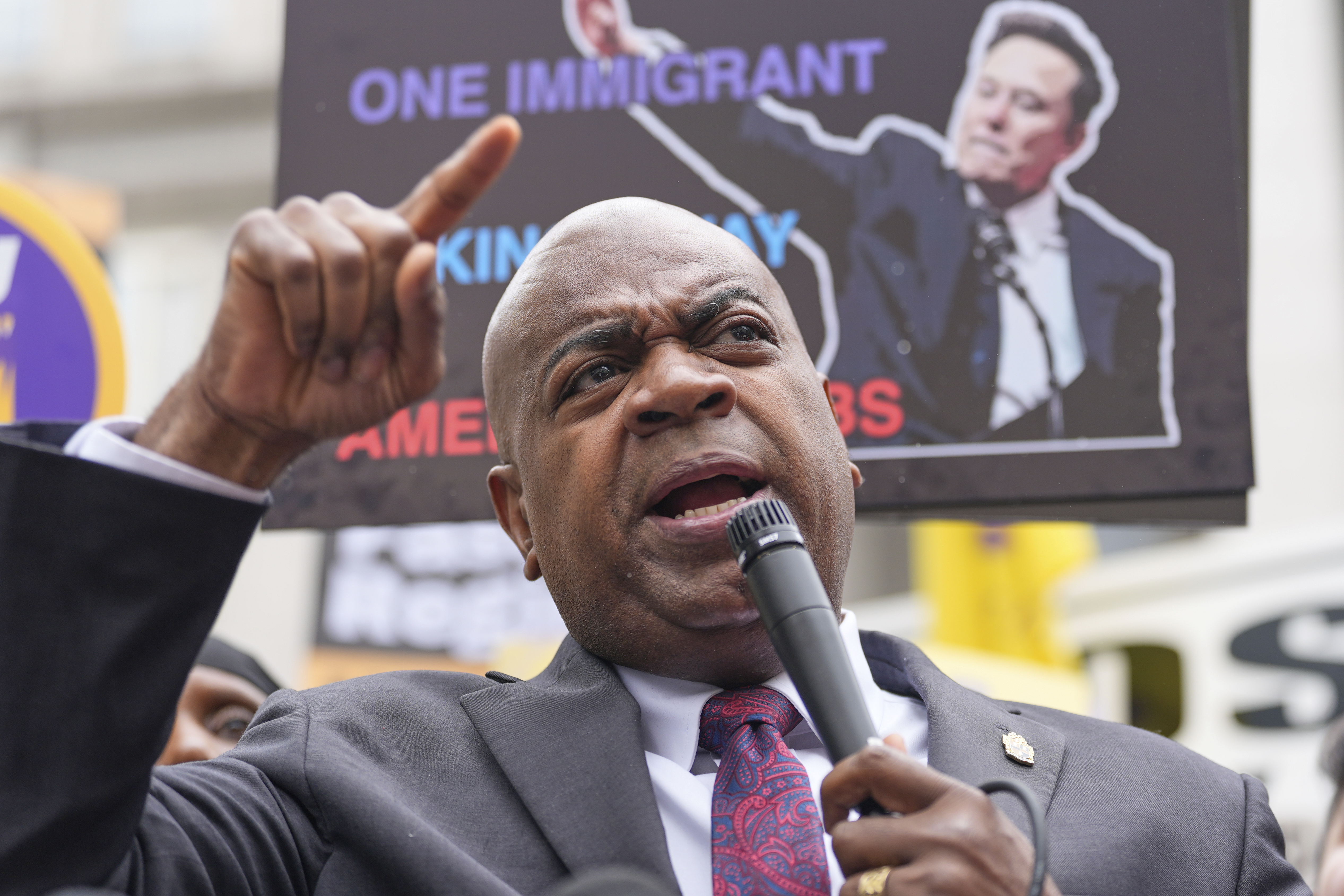 Ras Baraka speaks into a microphone at a protest.