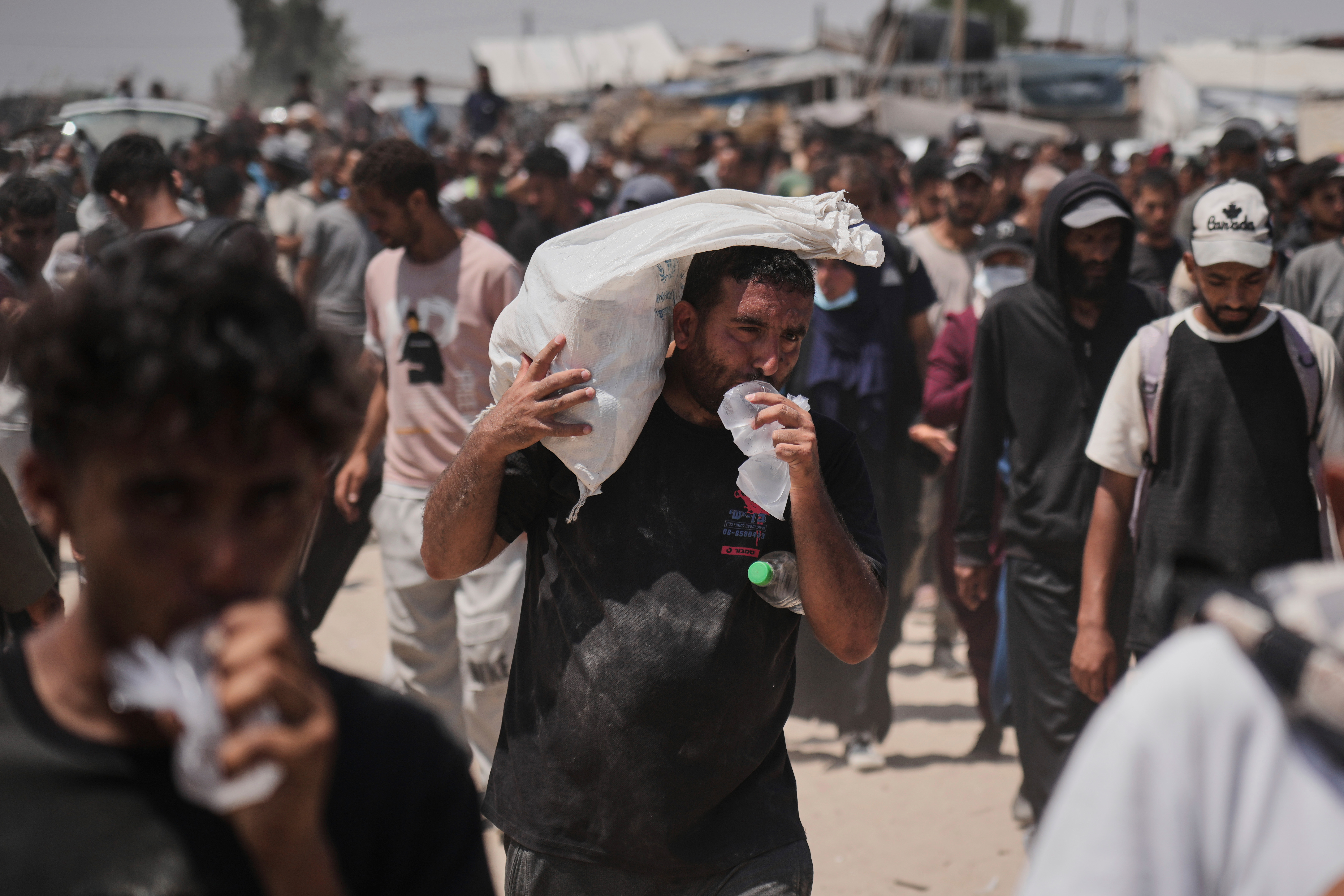 Palestinians carry bags containing food and humanitarian aid packages delivered by the Gaza Humanitarian Foundation, a U.S.-backed organization approved by Israel, in Rafah, southern Gaza Strip, Friday, June 6, 2025. [Abdel Kareem Hana/AP Photo]