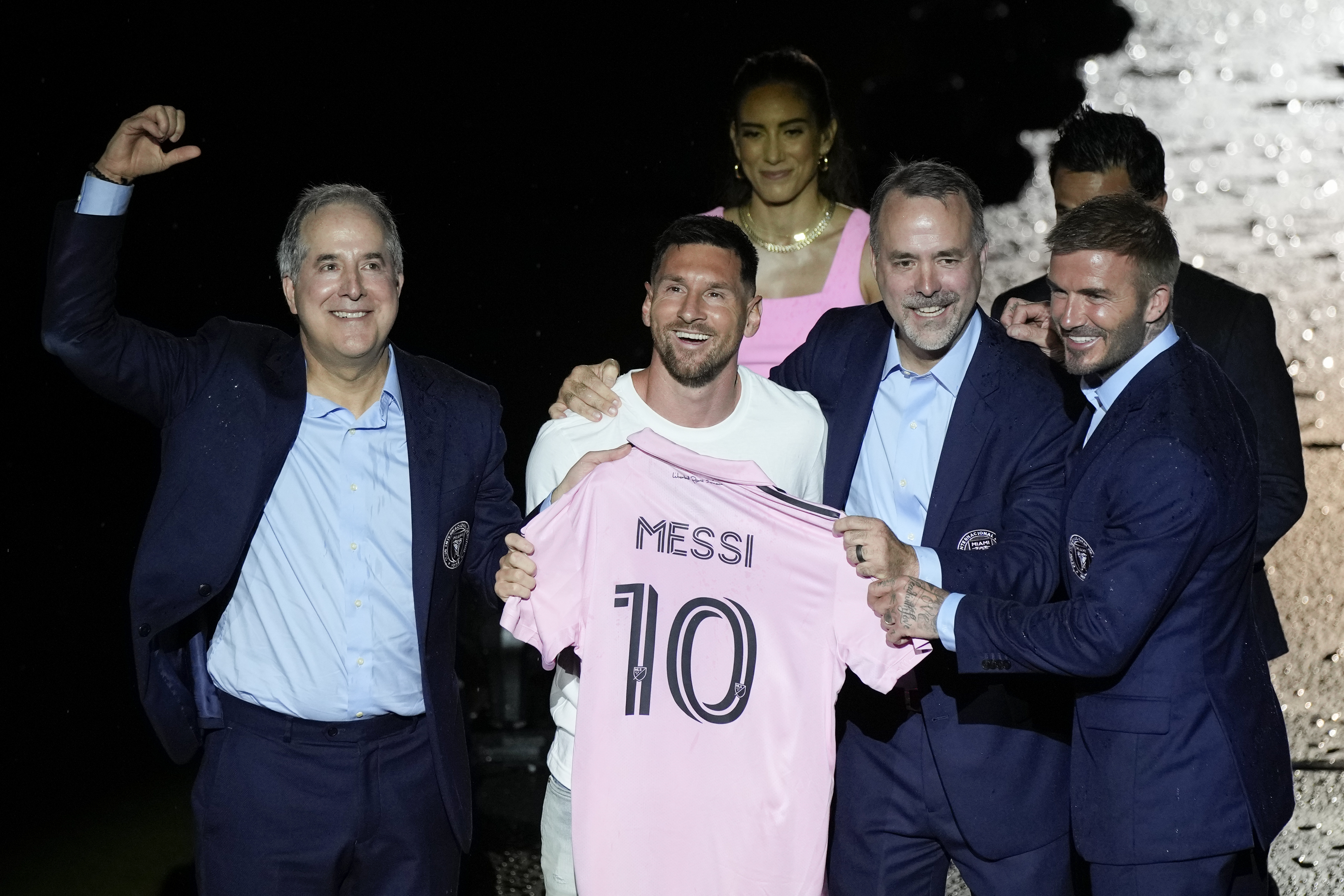 International superstar Lionel Messi, center left, holds his new Inter Miami team jersey as he poses with team co-owners Jorge Mas, left, Jose Mas, second right, and David Beckham, right, at an event to present him to fans one day after his signing, Sunday, July 16, 2023, in Fort Lauderdale
