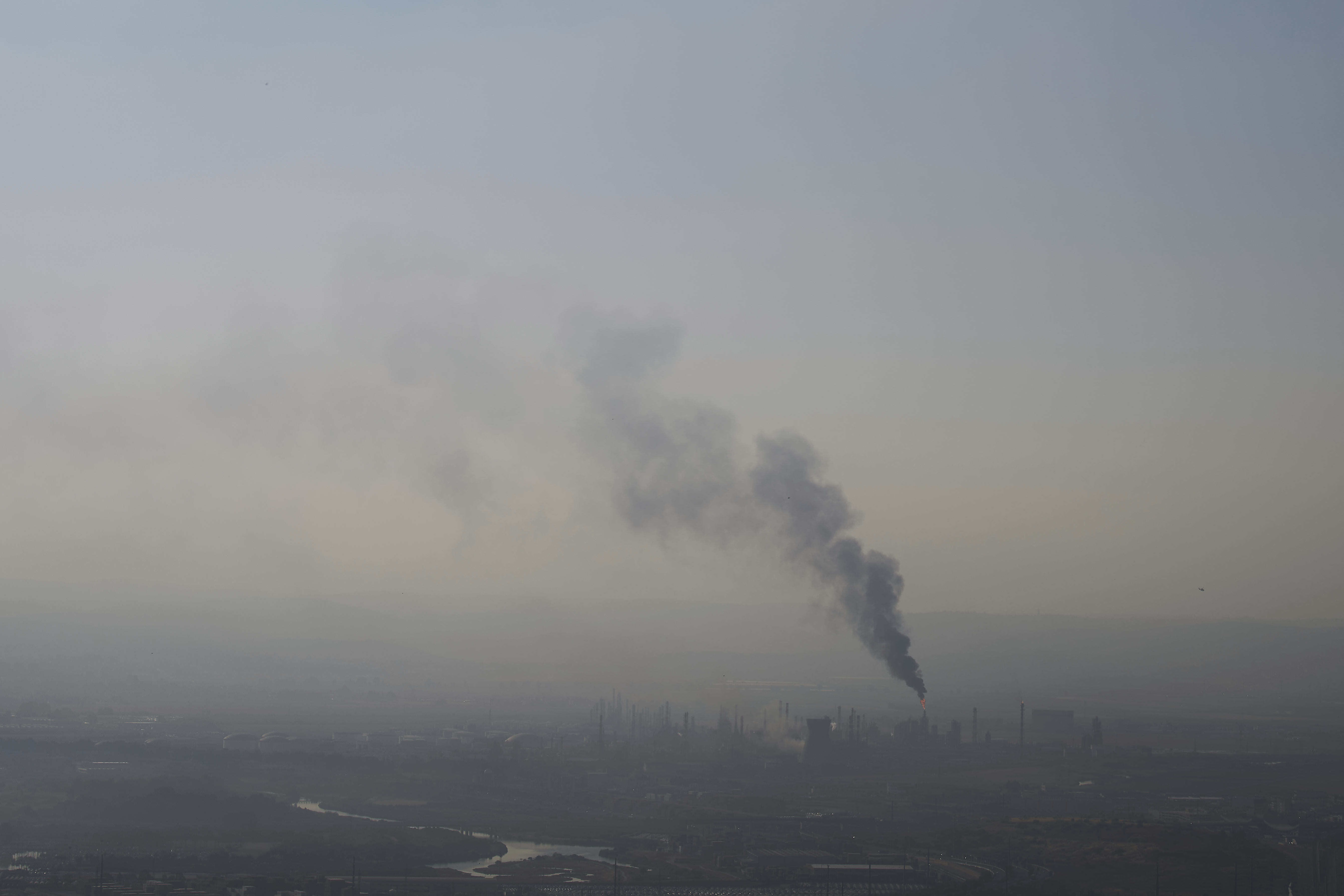 Smoke billows after an Iranian missile struck an oil refinery in Haifa