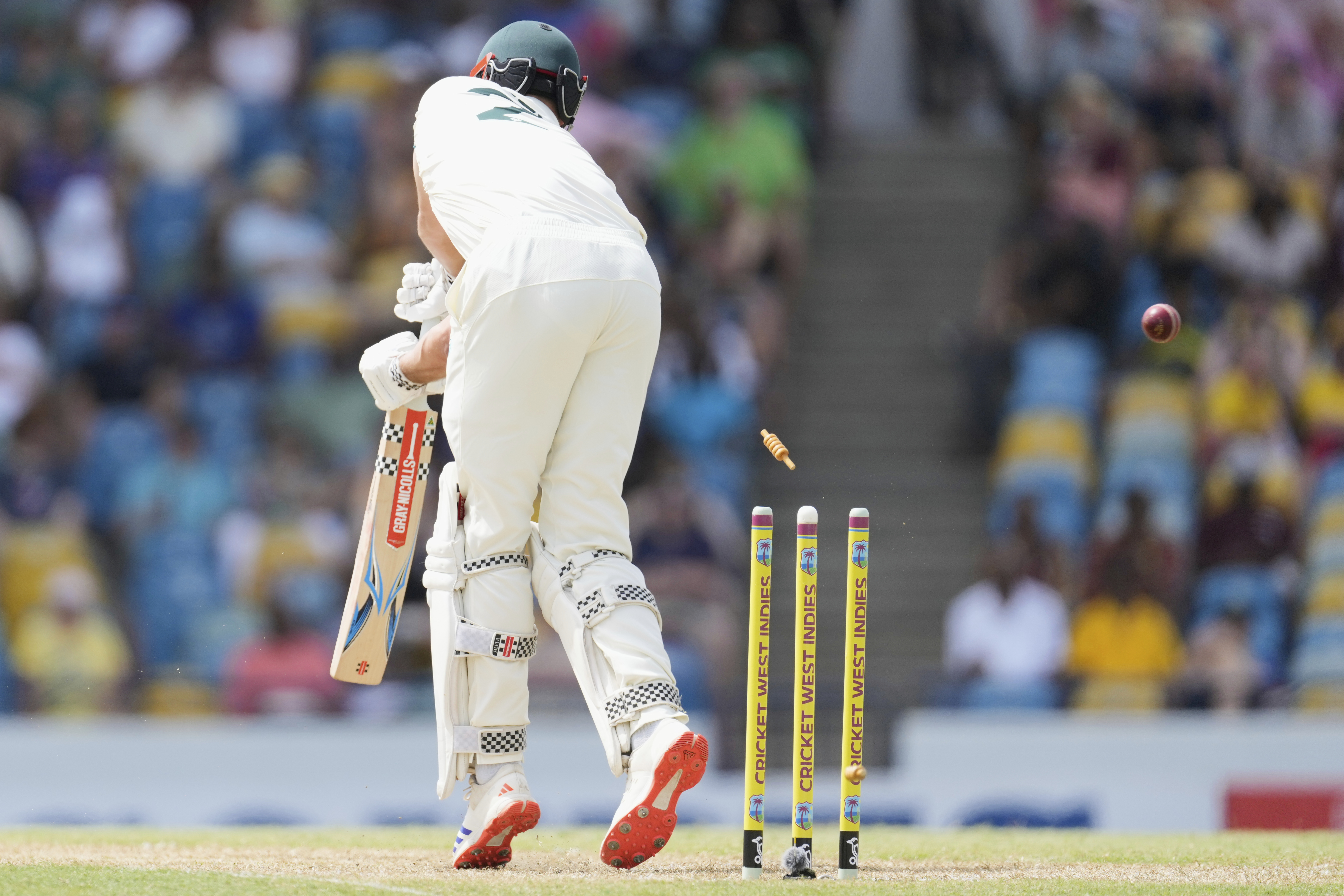 Australia's Beau Webster is bowled by West Indies' Shamar Joseph during day one of the first cricket Test match at Kensington Stadium in Bridgetown, Barbados, Wednesday, June 25, 2025. (AP Photo/Ricardo Mazalan)