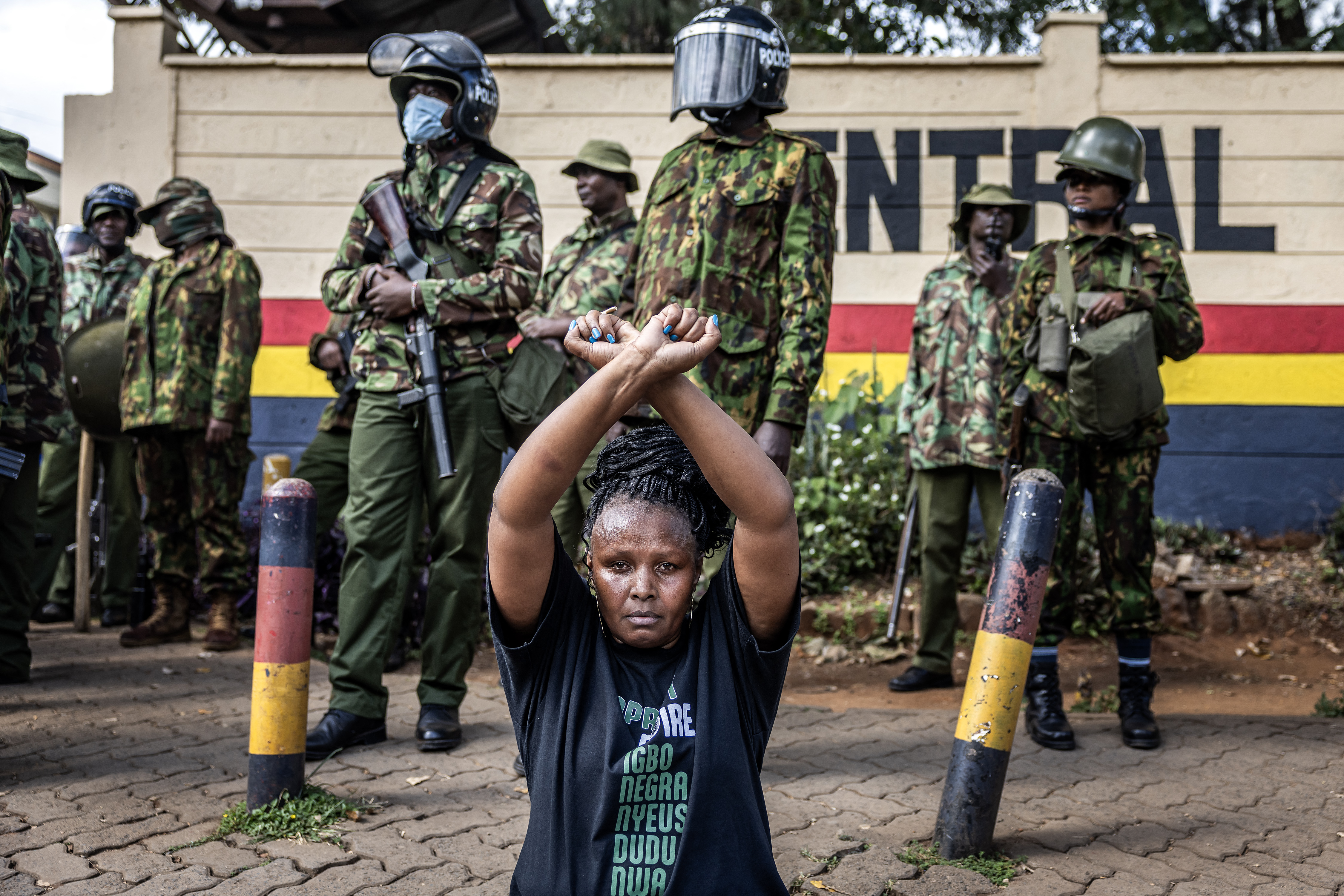 A protester gestures as she sits on the road during a protest over the death of blogger Albert Ojwang in police custody, at the Central Police Station in Nairobi, Kenya