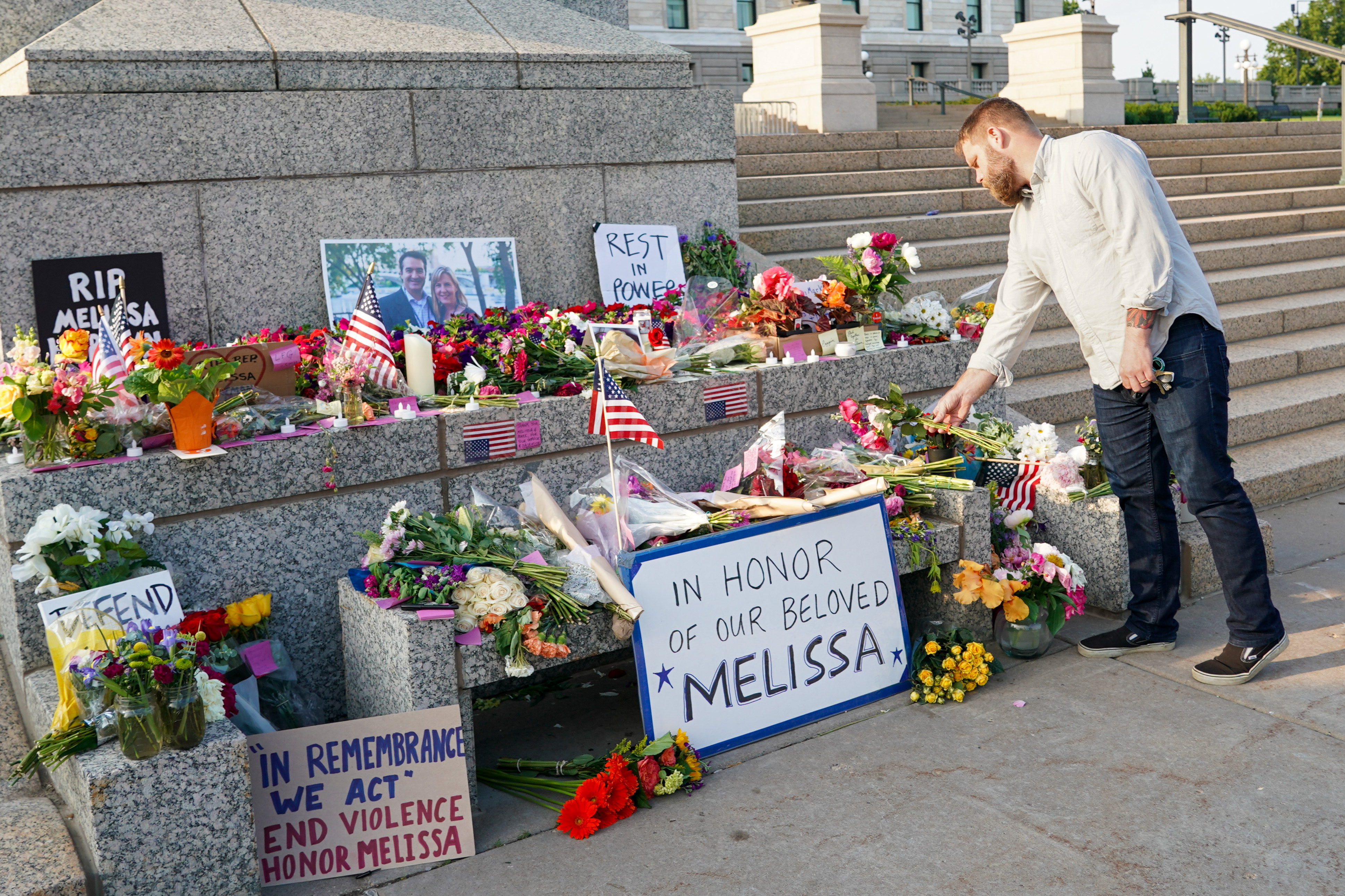 epa12178141 Devin Bruce of Minneapolis places flowers at a memorial for US Minnesota State Representative Melissa Hortman and her husband, Mark, who were fatally shot in their Brooklyn Park home on 14 June, at the State Capitol in Saint Paul, Minnesota, USA, 15 June 2025. The suspect, 57-year-old Vance Luther Boelter, is also the suspect in a separate shooting attack on Democratic State Senator John Hoffman and his wife, Yvette, on the same day. EPA-EFE/CRAIG LASSIG