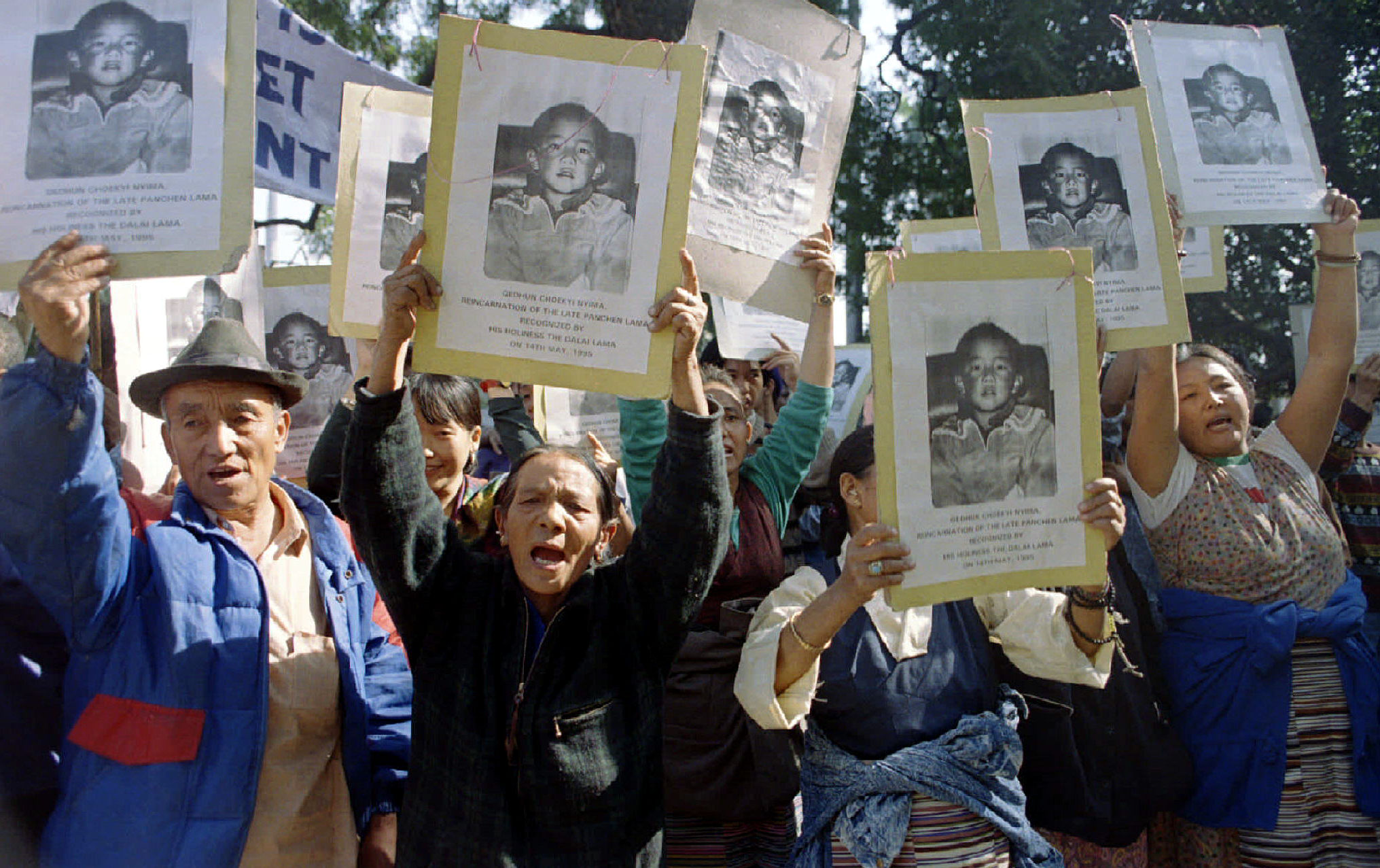Tibetans in New Delhi carry pictures of Gedun Choekyi Nyima, the Panchen Lama reincarnation recognised by the Dalai Lama, shout anti-Chinese slogans to mark their protest on December 8 against enthronement of another Panchen Lama recognised by the Chinese government in Tibet today. Reuters