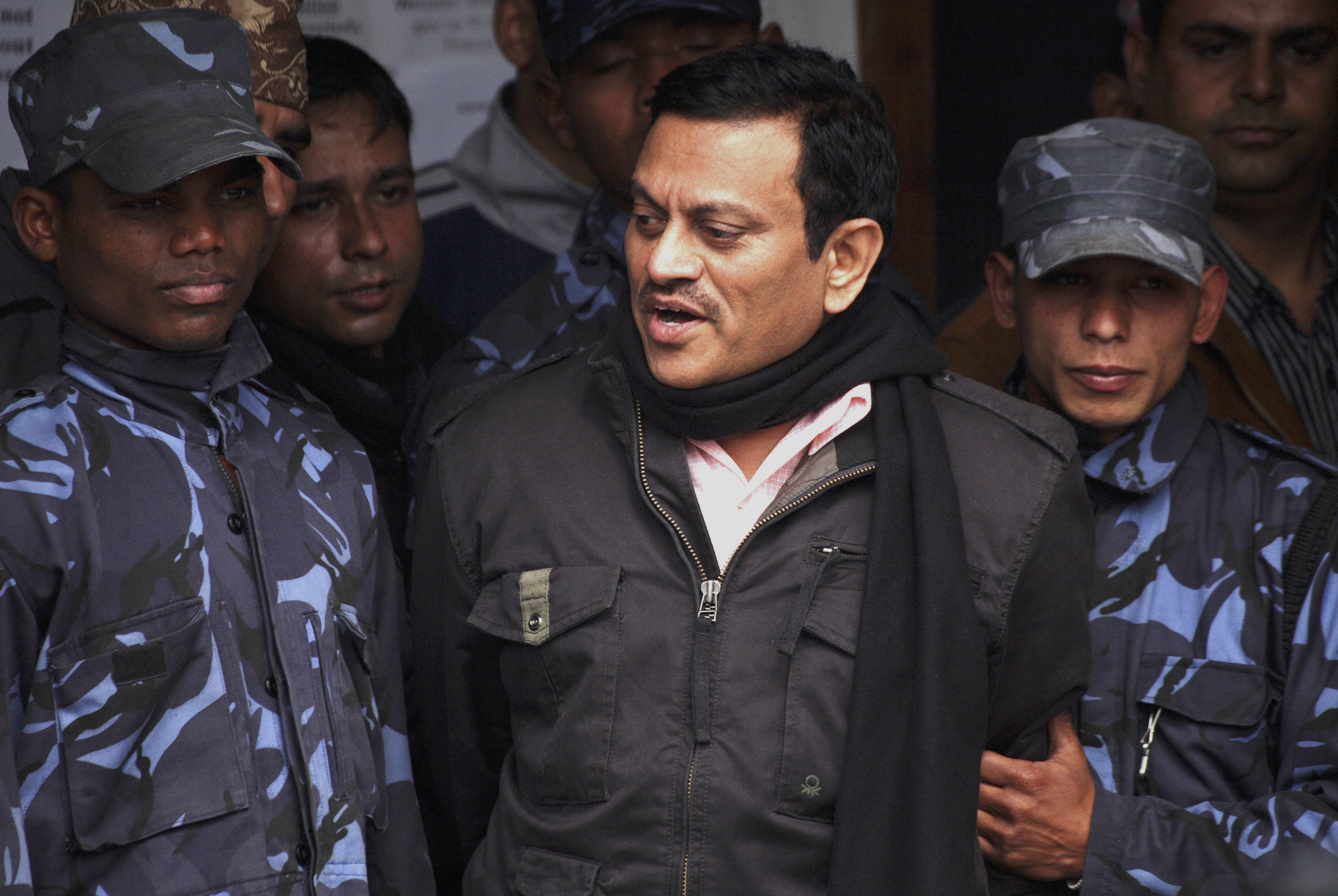 Amit Kumar (C), 40, speaks to the media while in police custody in Kathmandu February 8, 2008. Nepal's police have arrested Kumar, an Indian man suspected of being the mastermind of an illegal kidney transplant racket in India, a top force official said. REUTERS/Gopal Chitrakar (NEPAL)