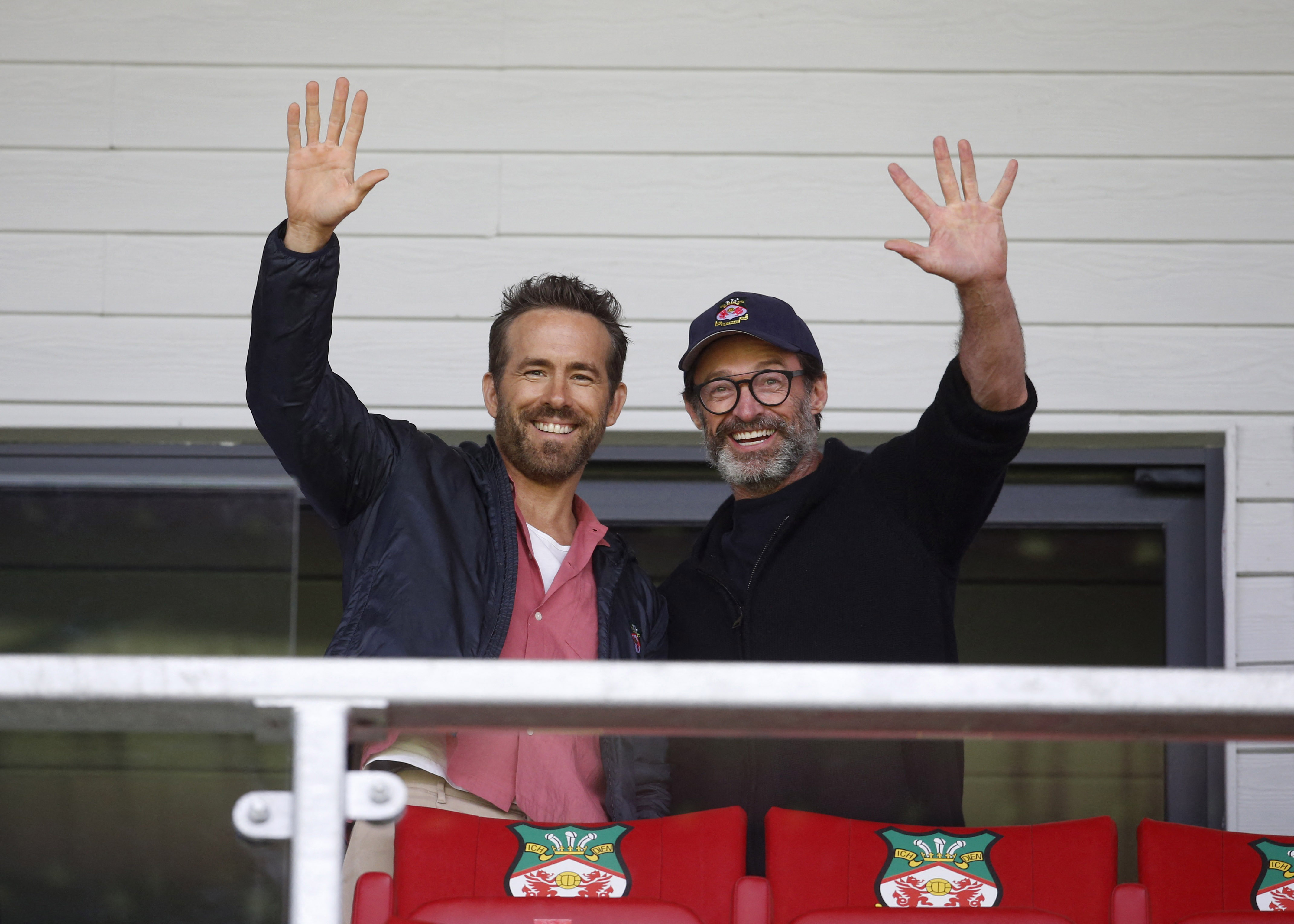 Wrexham co-owner Ryan Reynolds and actor Hugh Jackman pose for a picture in the stands