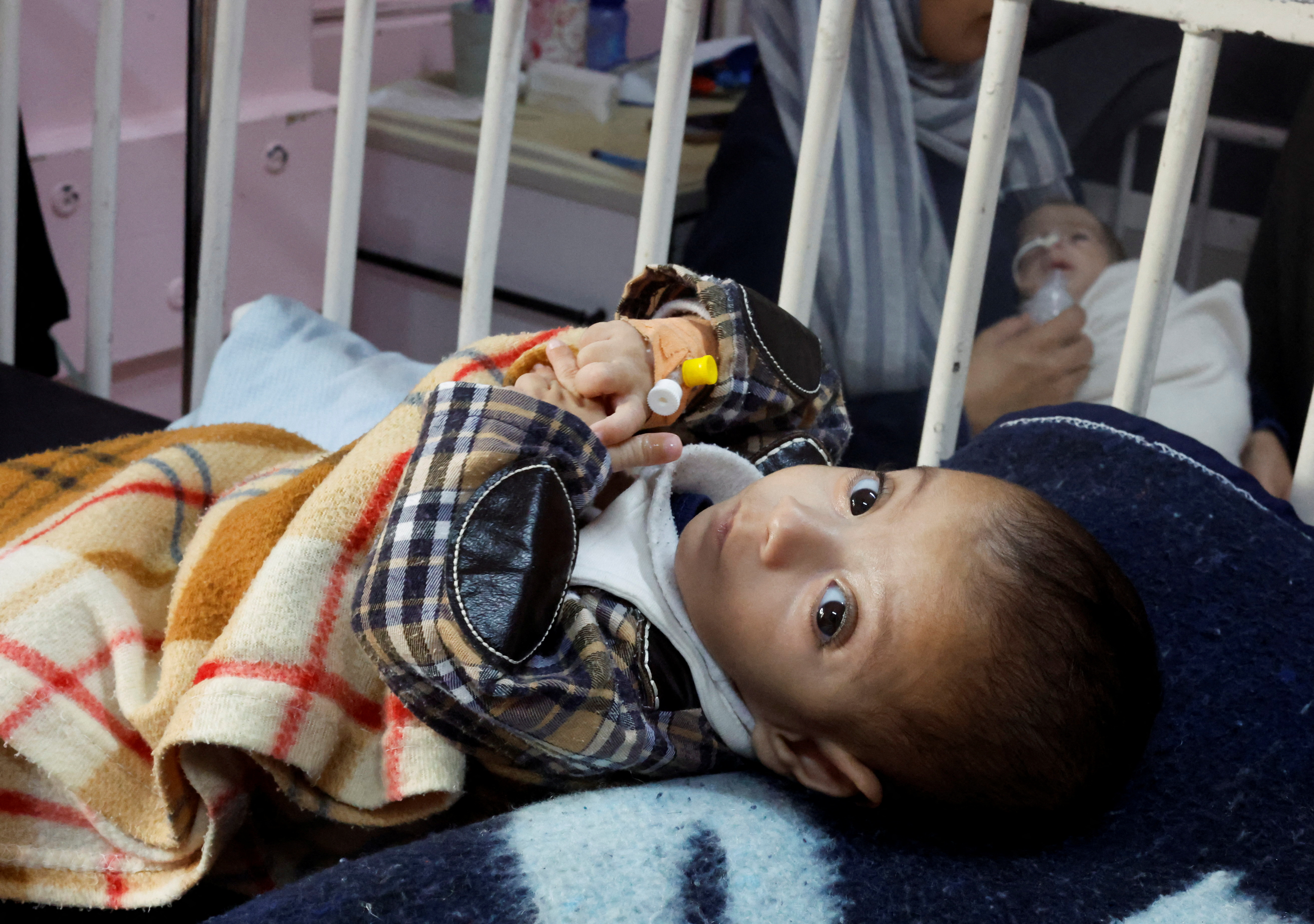 A Palestinian boy diagnosed with malnutrition, according to doctors, lies in a bed receiving treatment at the ICU of Nasser hospital, in Khan Younis in the southern Gaza Strip December 7, 2024. REUTERS/Mohammed Salem