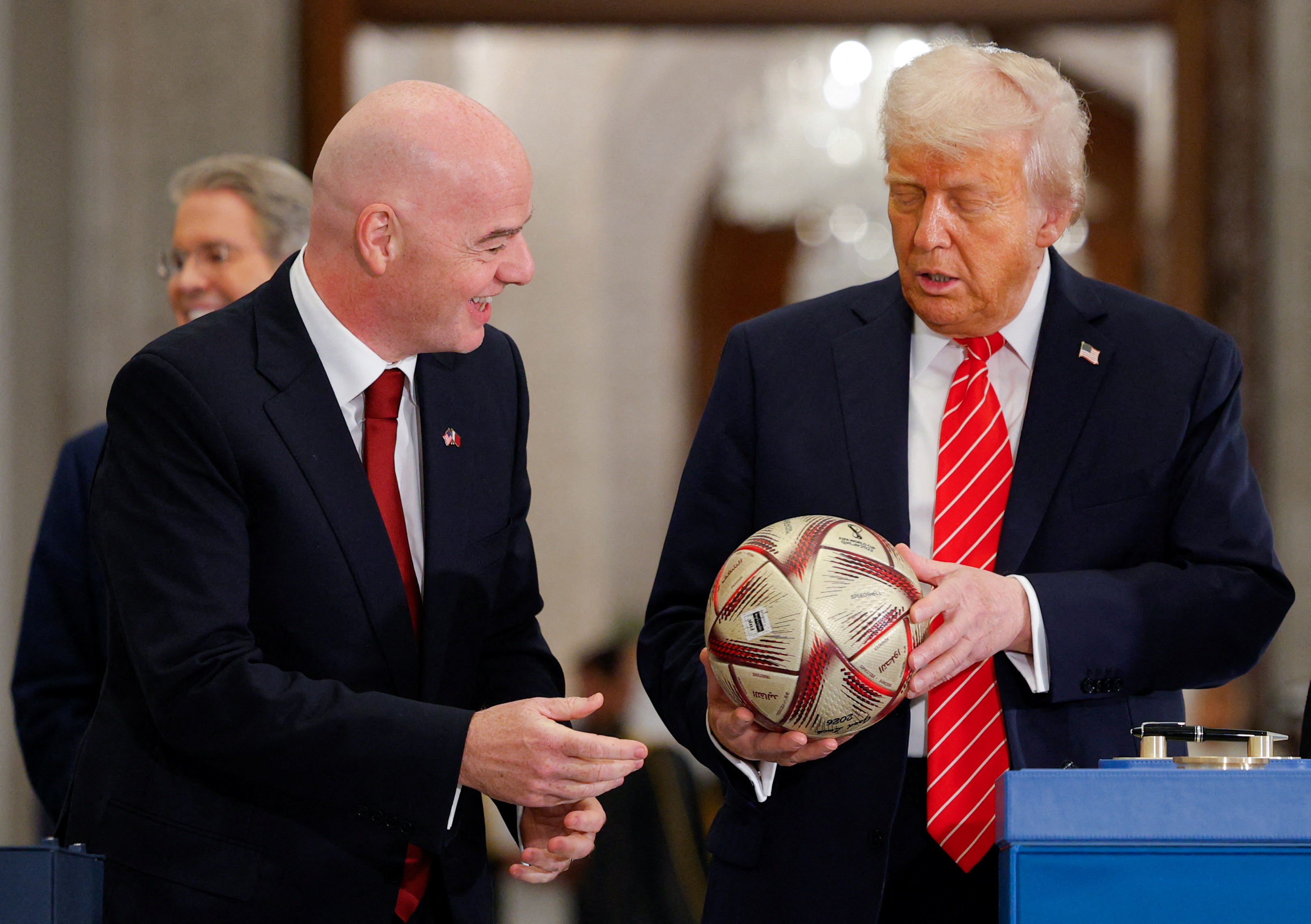 U.S. President Donald Trump holds a soccer ball as he attends an event with Qatar's Emir Tamim bin Hamad Al Thani (not pictured) and FIFA President Gianni Infantino