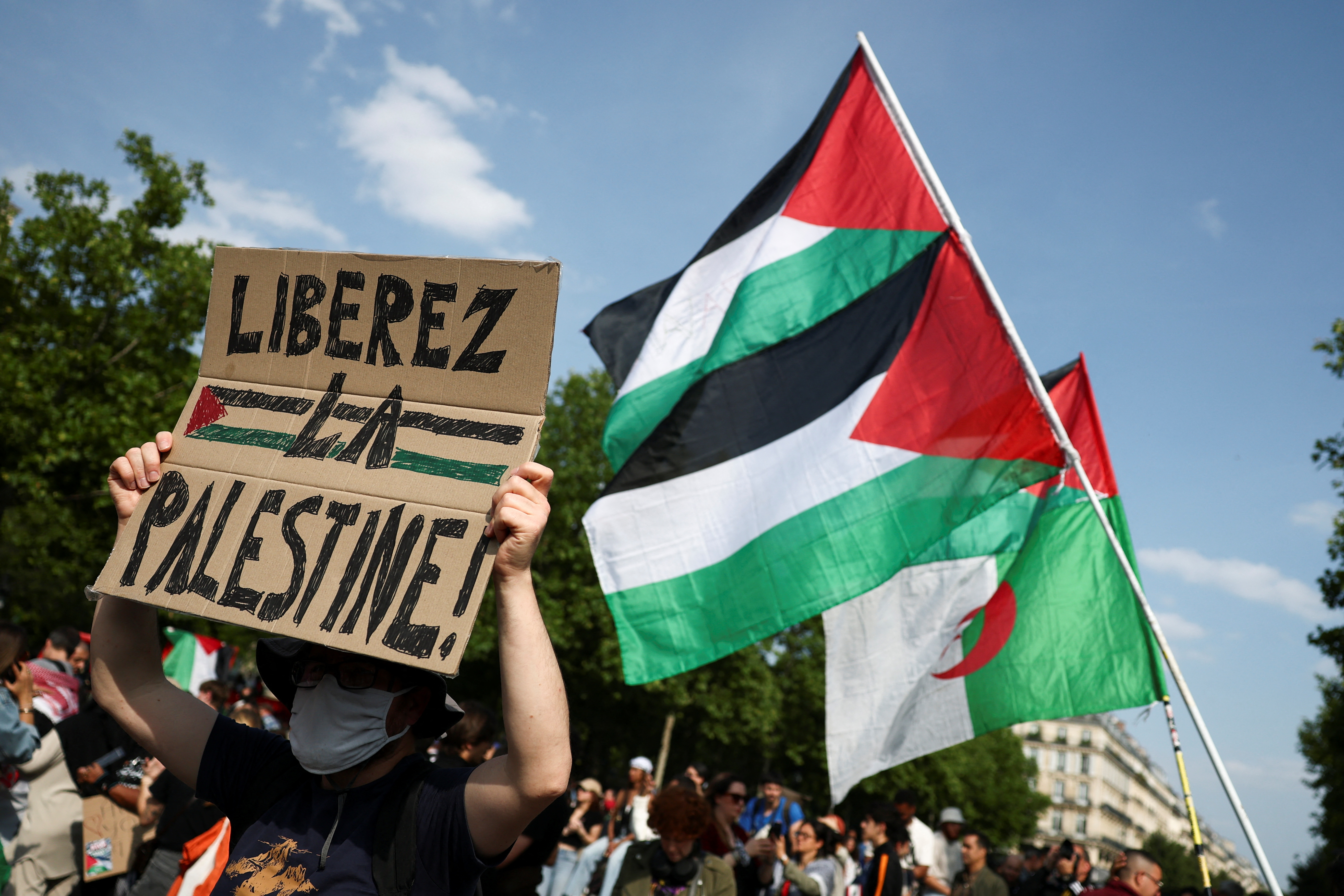 A man holds a placard reading "Free Palestine" during a demonstration, to protest after Israeli forces seize the British-flagged yacht, Madleen, which is operated by the pro-Palestinian Freedom Flotilla Coalition, was aiming to deliver a symbolic amount of aid to Gaza later on Monday and raise international awareness of the humanitarian crisis there, at the Place de la Republique in Paris, France June 9, 2025. REUTERS/Sarah Meyssonnier