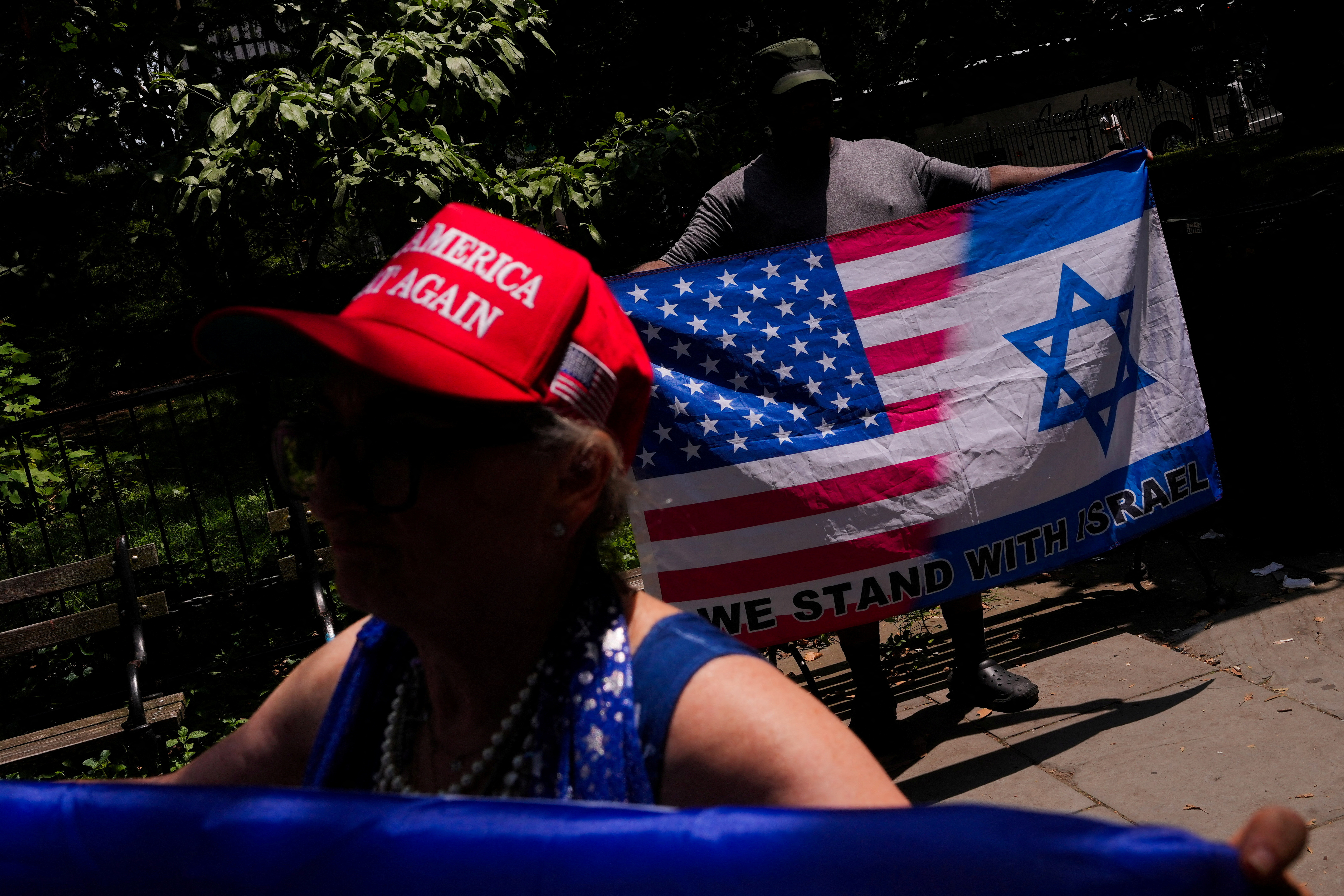 Pro-Israeli counter protestors hold American-Israeli flags, as they disrupt a press conference and rally by members of the Professional Staff Congress (PSC) CUNY, American Federation of Teachers (AFT) and the American Association of University Professors (AAUP), ahead of College administrators testifying to the House Education and Workforce Committee, in New York City, U.S.,