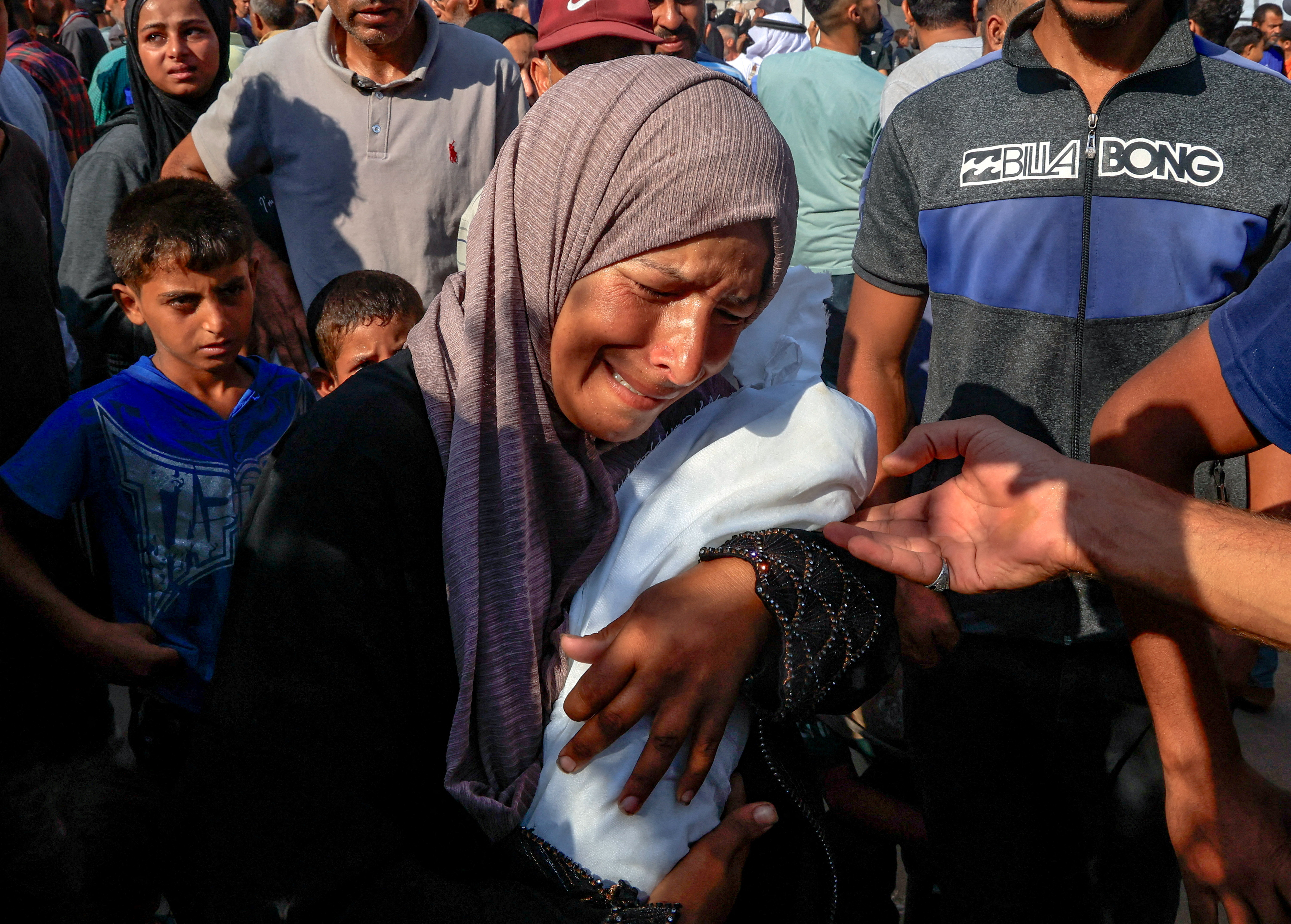 Palestinian mother Alaa Al-Najjar mourns her three-month-old baby Yehia, who died due to malnutrition
