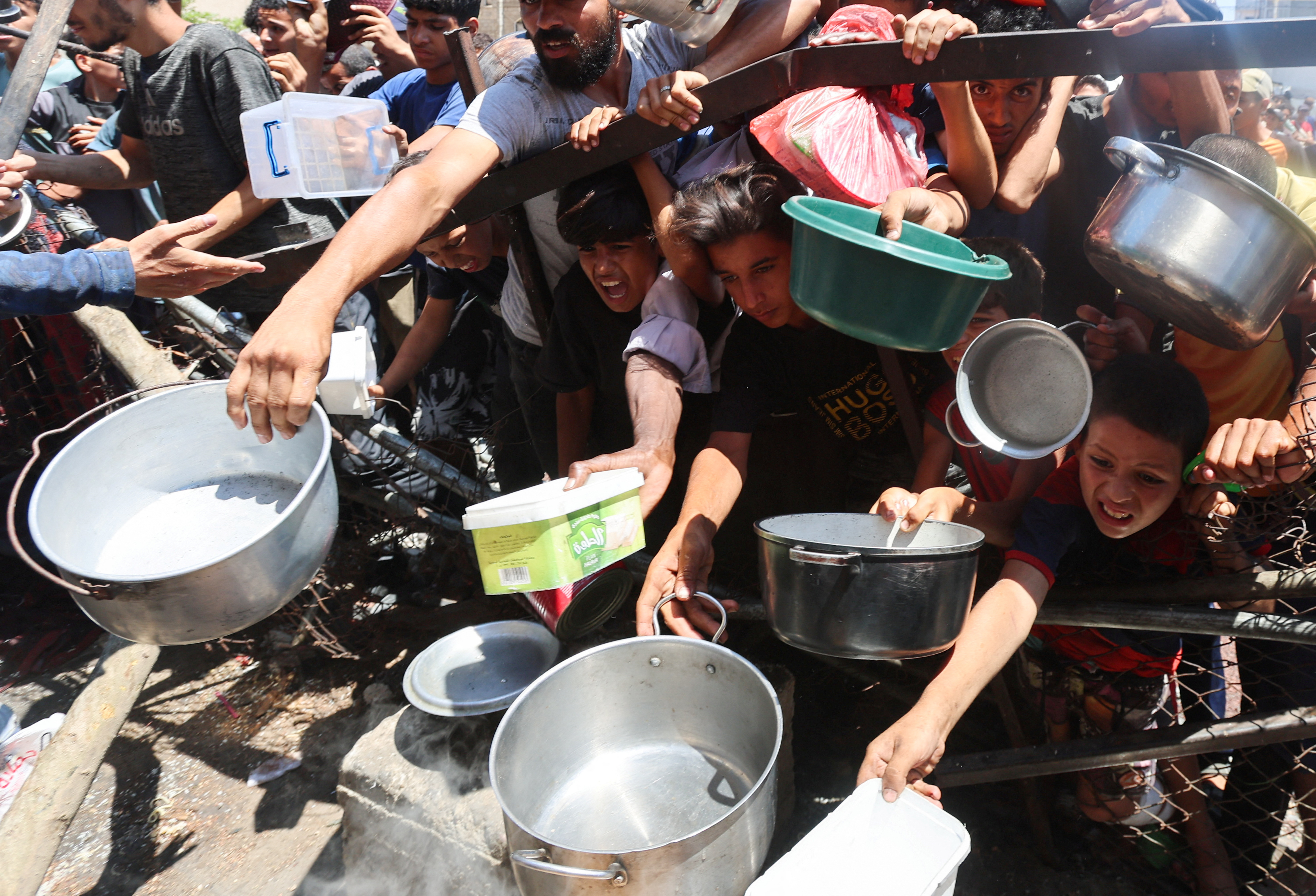 Photos: Palestinians gather at a charity kitchen un Nuseirat