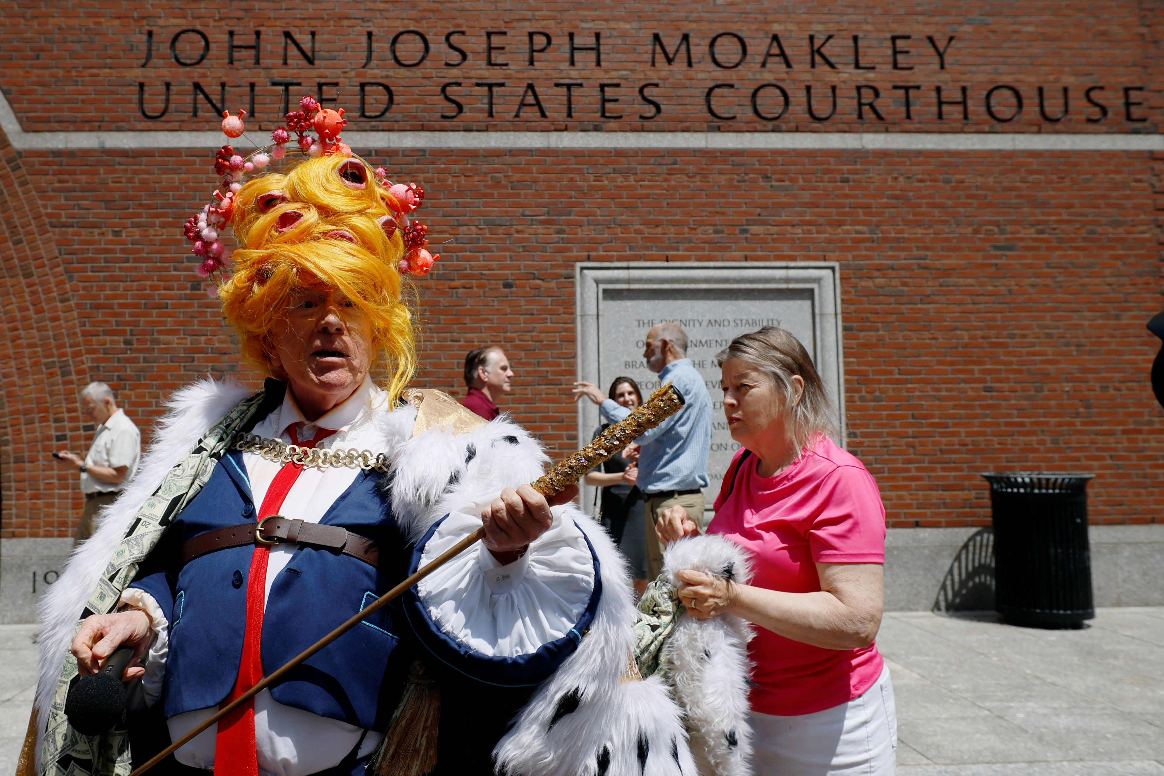 A drag performer dresses as Trump with a regal cape and sceptre.
