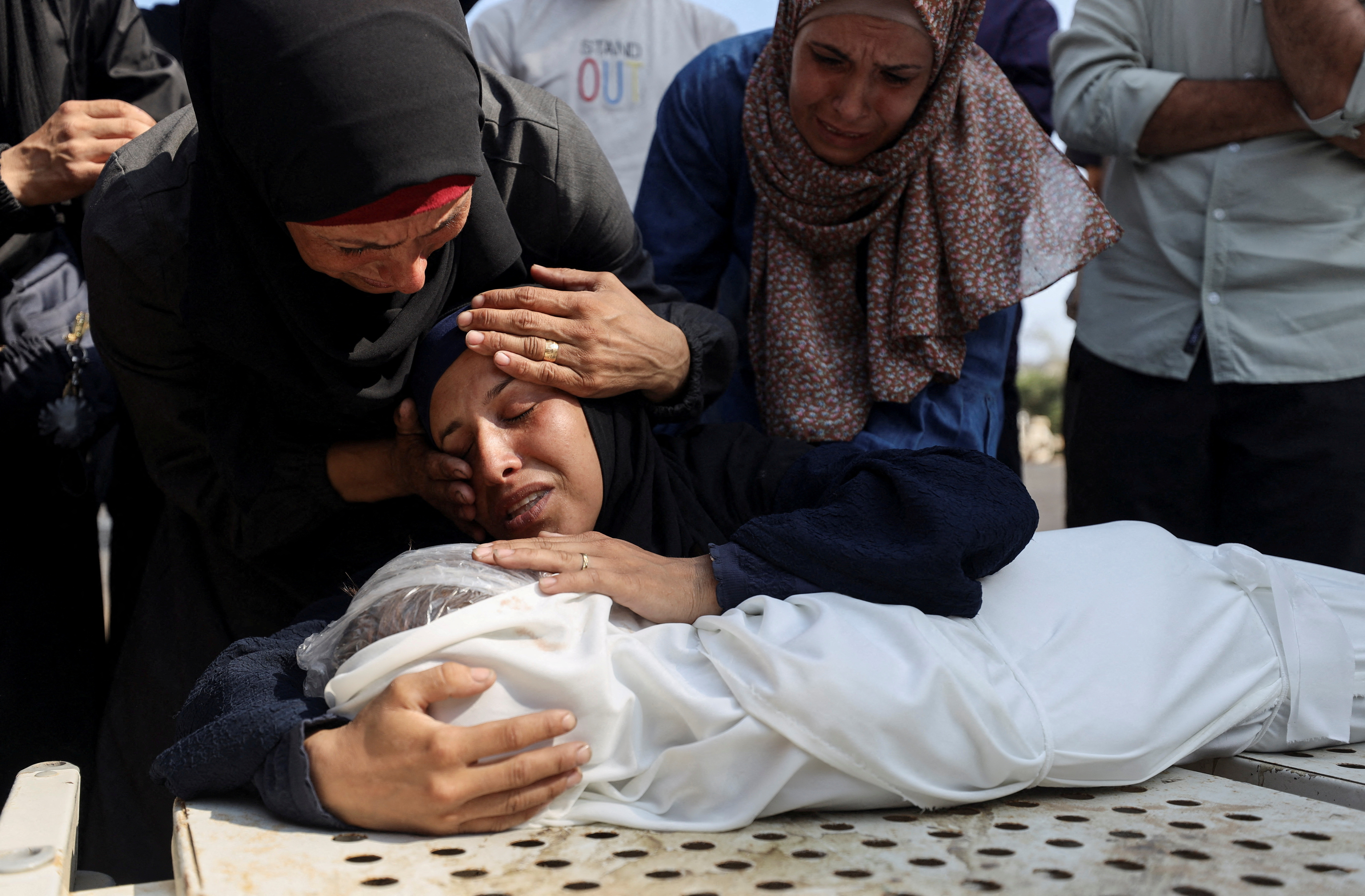 Mourners react next to the body of a Palestinian child killed in an Israeli strike, according to medics, at Shifa hospital in Gaza City July 22, 2025.