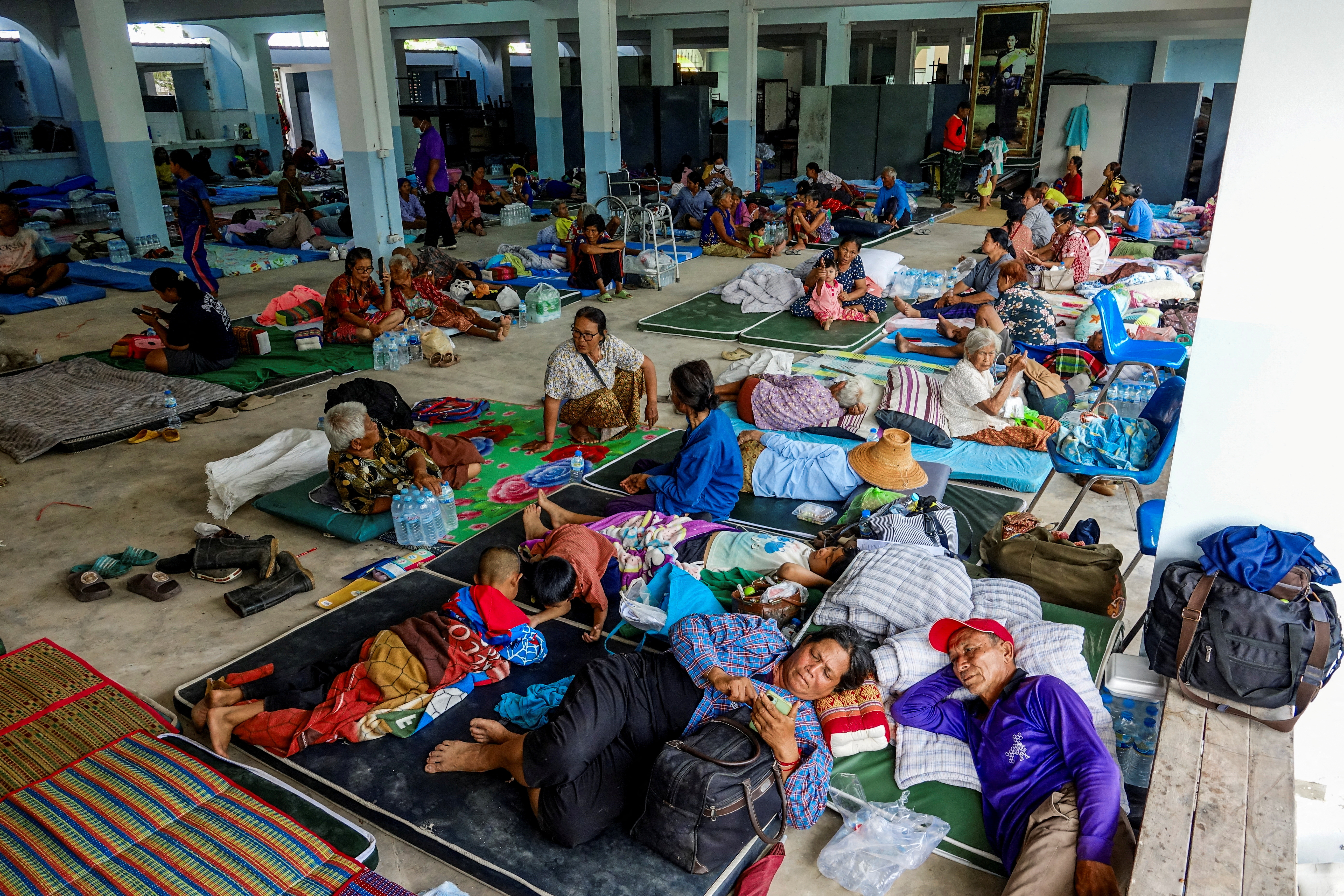 People rest at a shelter.