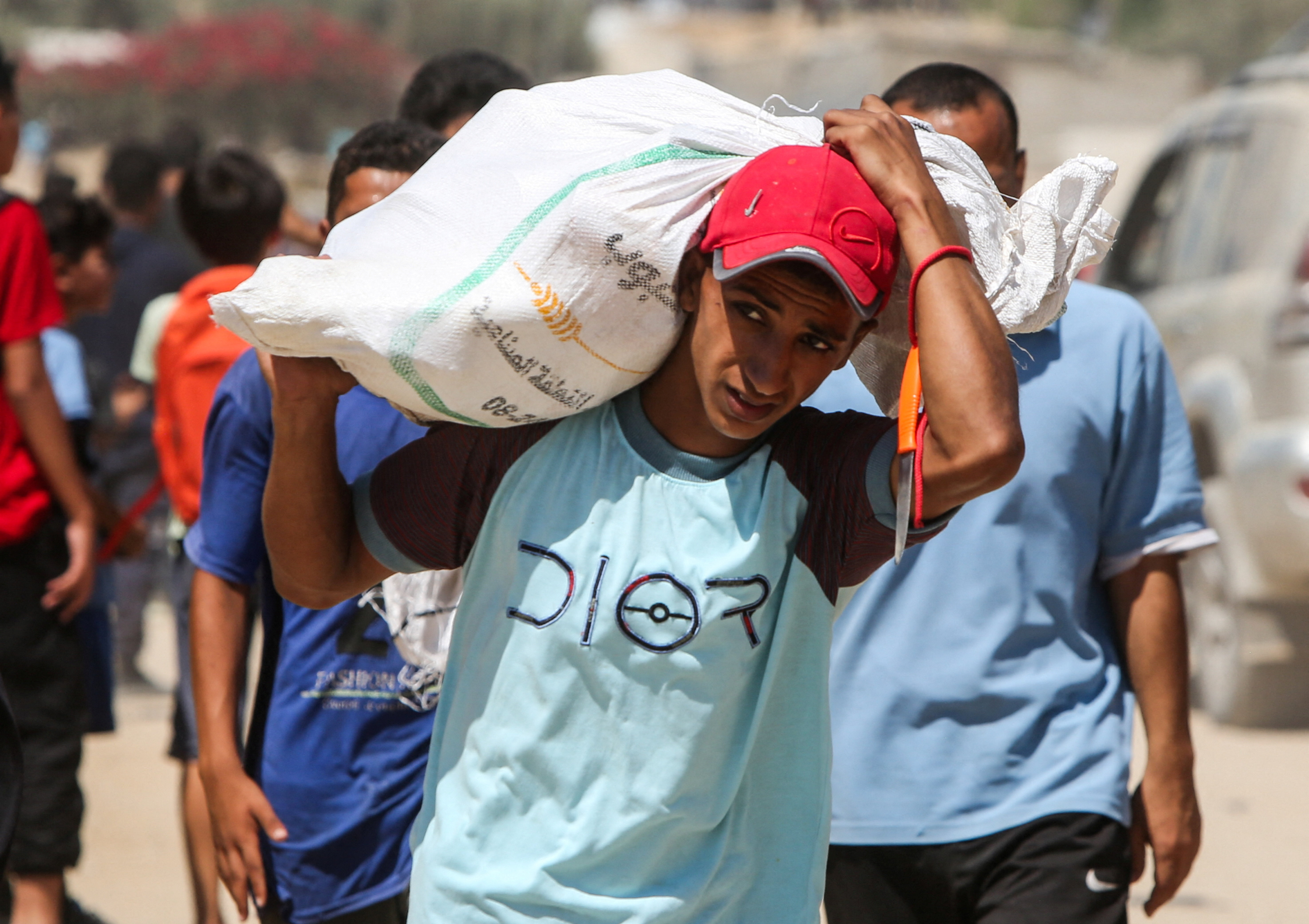 Palestinians collect aid parcels that were airdropped in Zawayda, in the central Gaza Strip, July 31, 2025. [Hatem Khaled/Reuters]