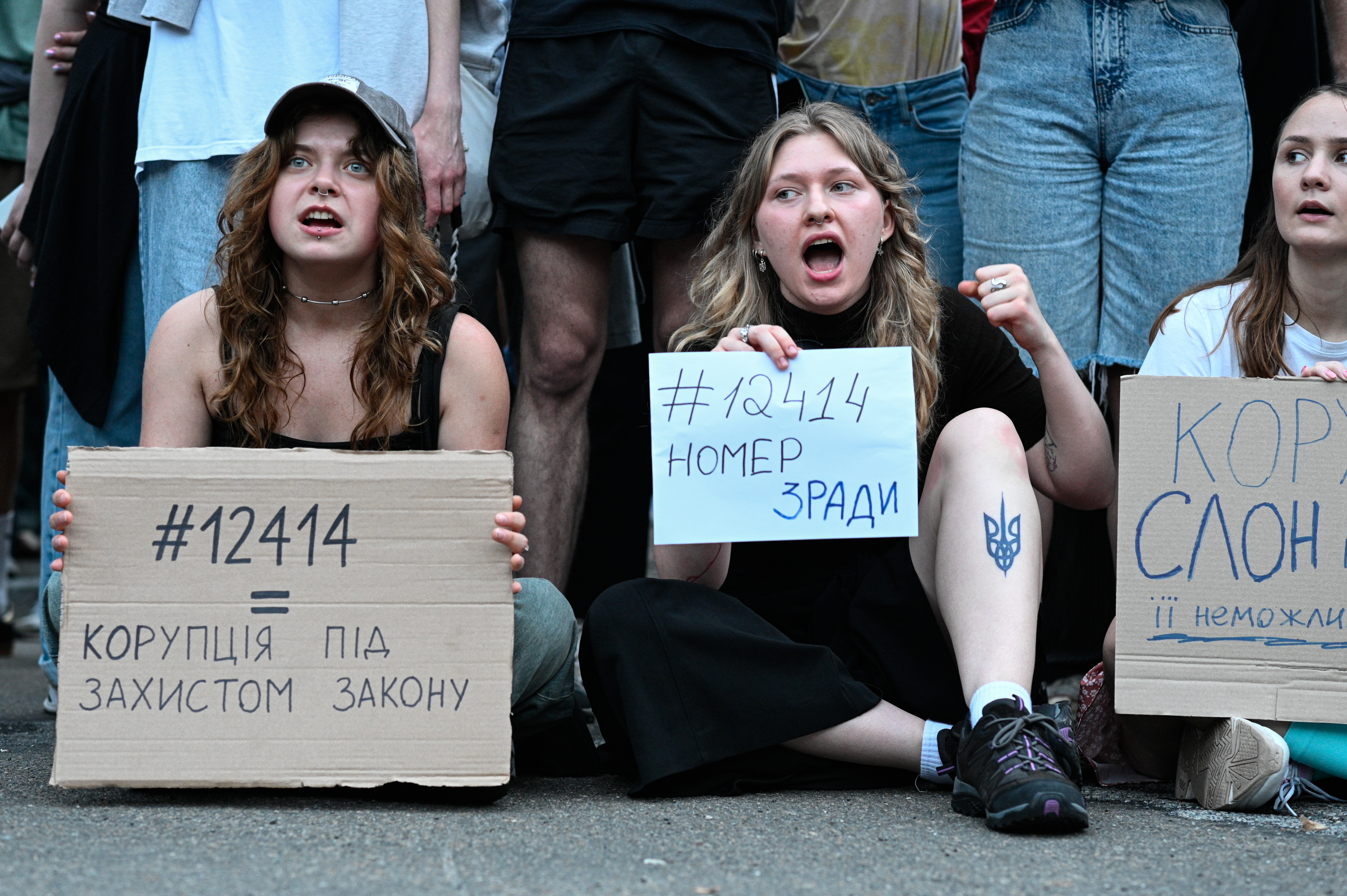 Kyiv residents take part in a rally against the implementation of Zelenskky's bill that undermines the power of anticorruption agencies.