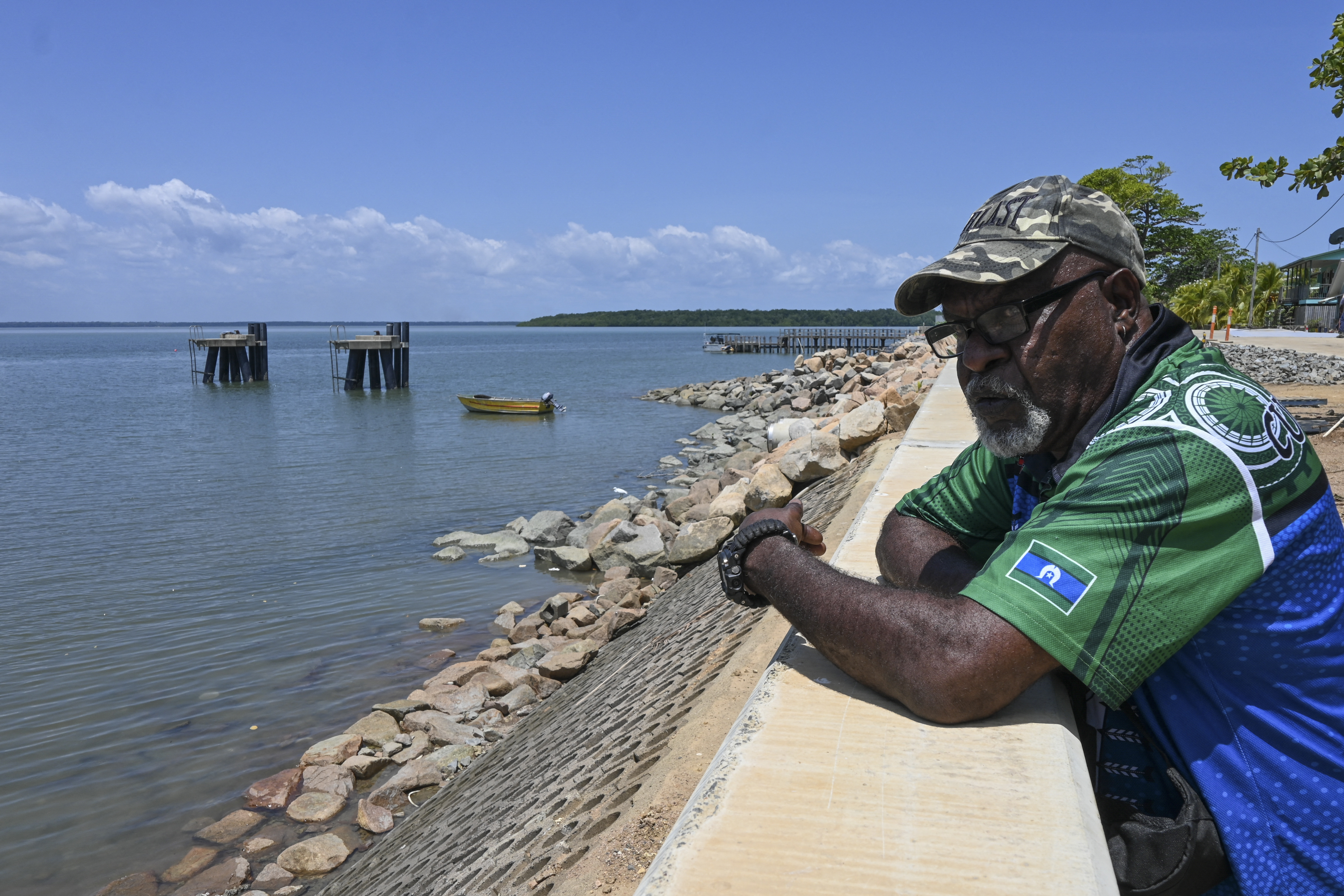 Plaintiff Paul Kabai looking over at the seawall on an island.