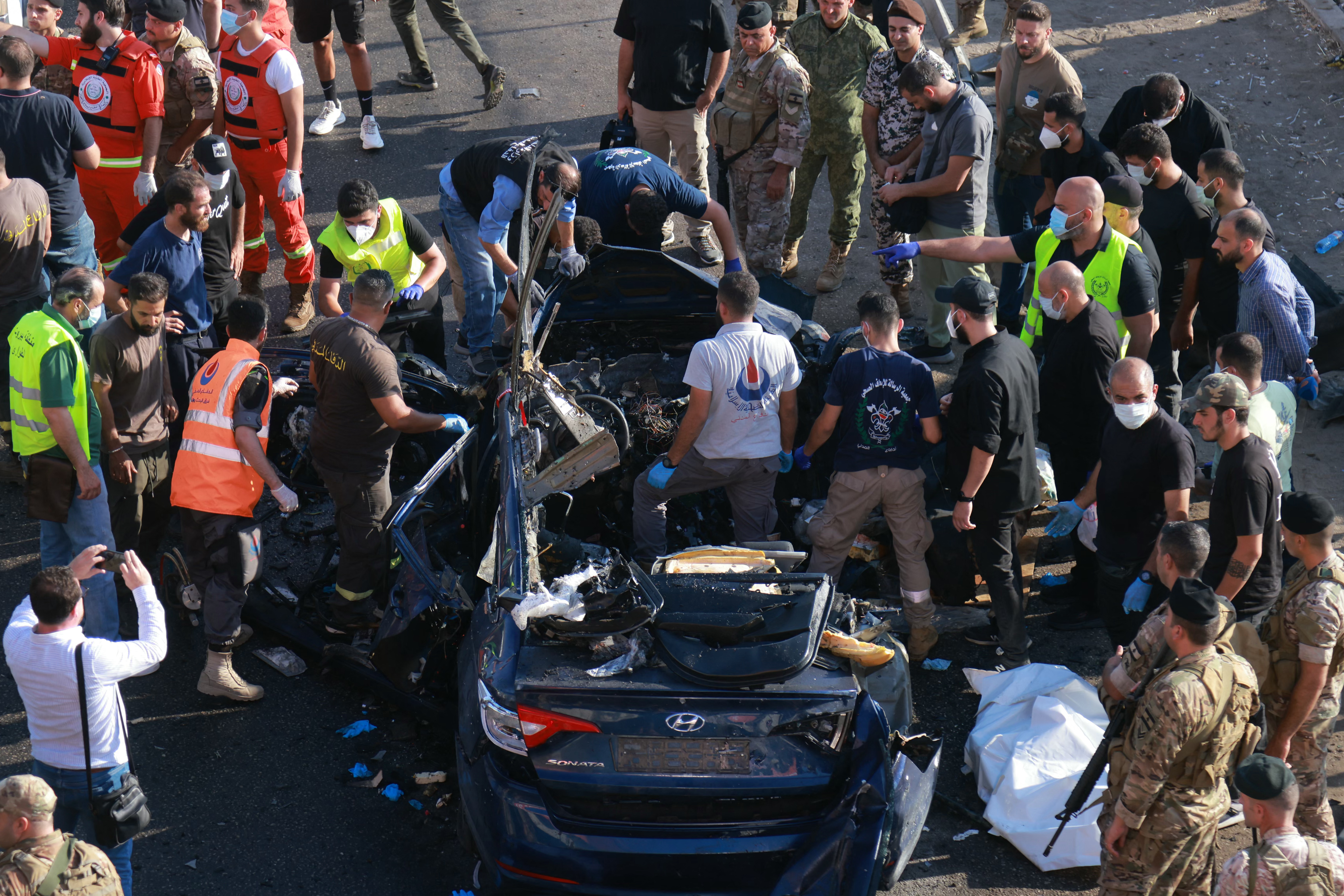 Lebanese emergency responders inspect the debris at the site of a reported Israeli strike on a vehicle in Khaldeh, south of the capital Beirut on July 3, 2025.