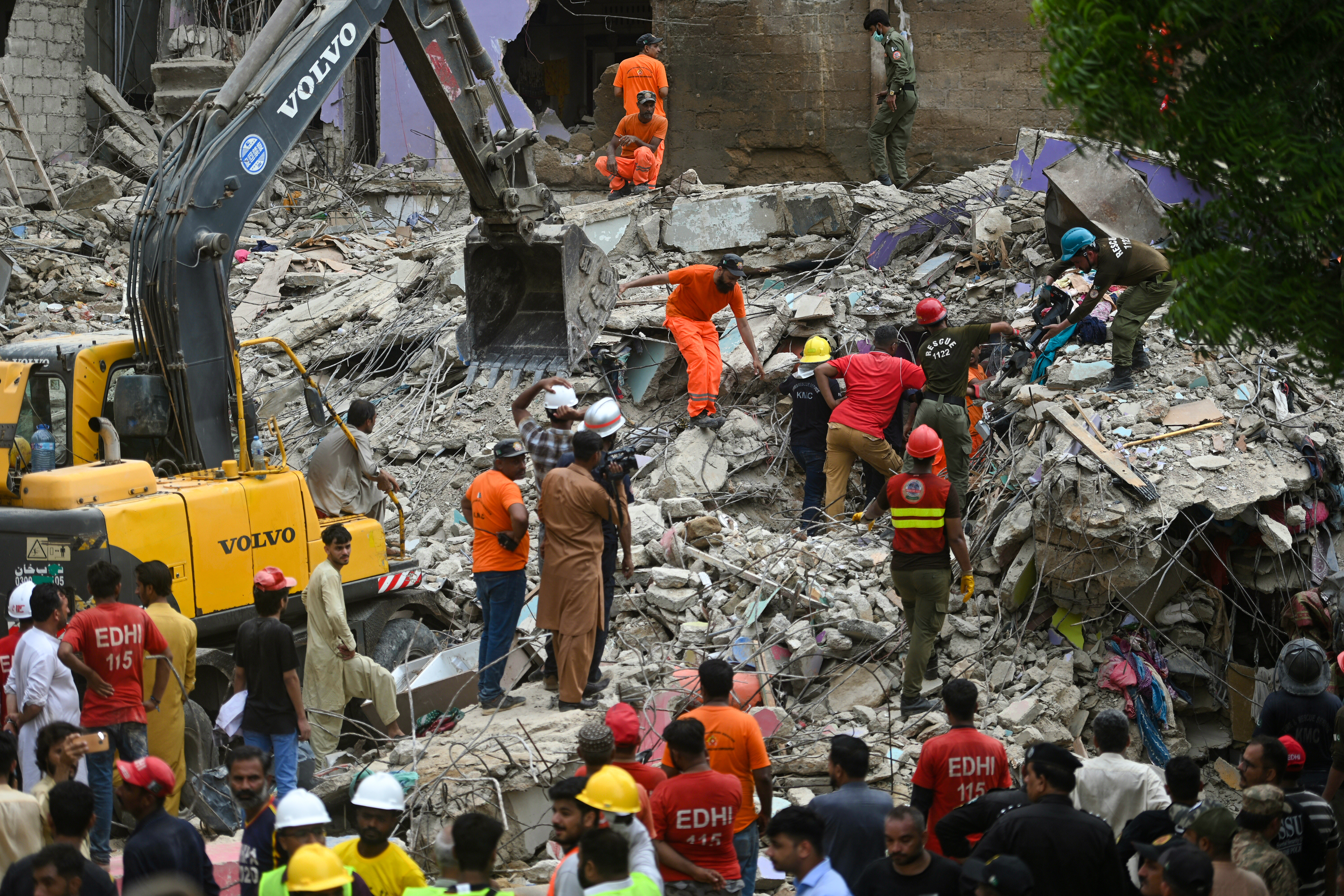 Rescue workers recover victims from the debris of the collapsed building