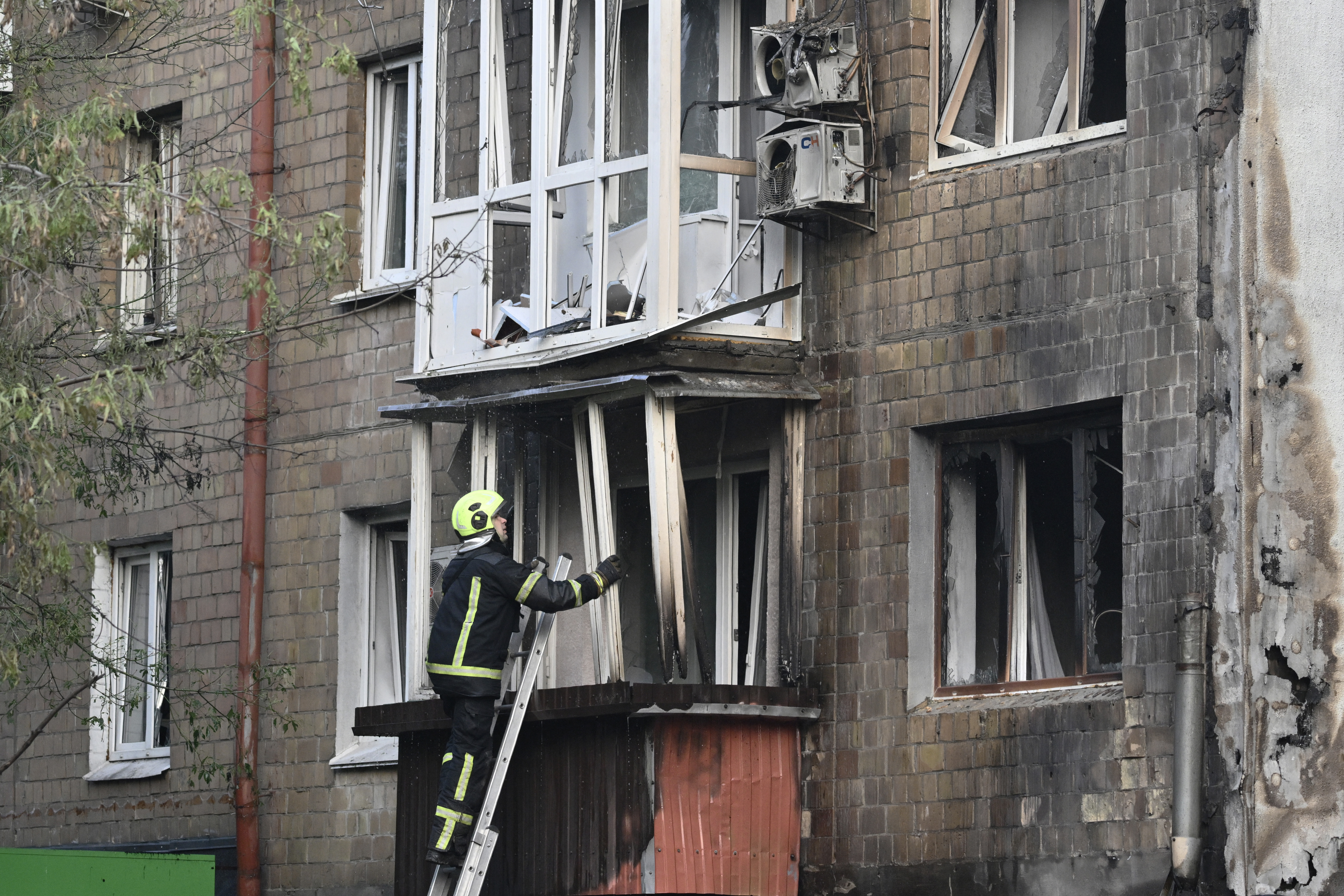 A Ukrainian firefighter works at a damaged residential building after a Russian missile and drone attack in Kyiv on July 10, 2025, amid the Russian invasion of Ukraine. Russian strikes on Ukraine's capital Kyiv killed at least two people [Genya Savilov/AFP]
