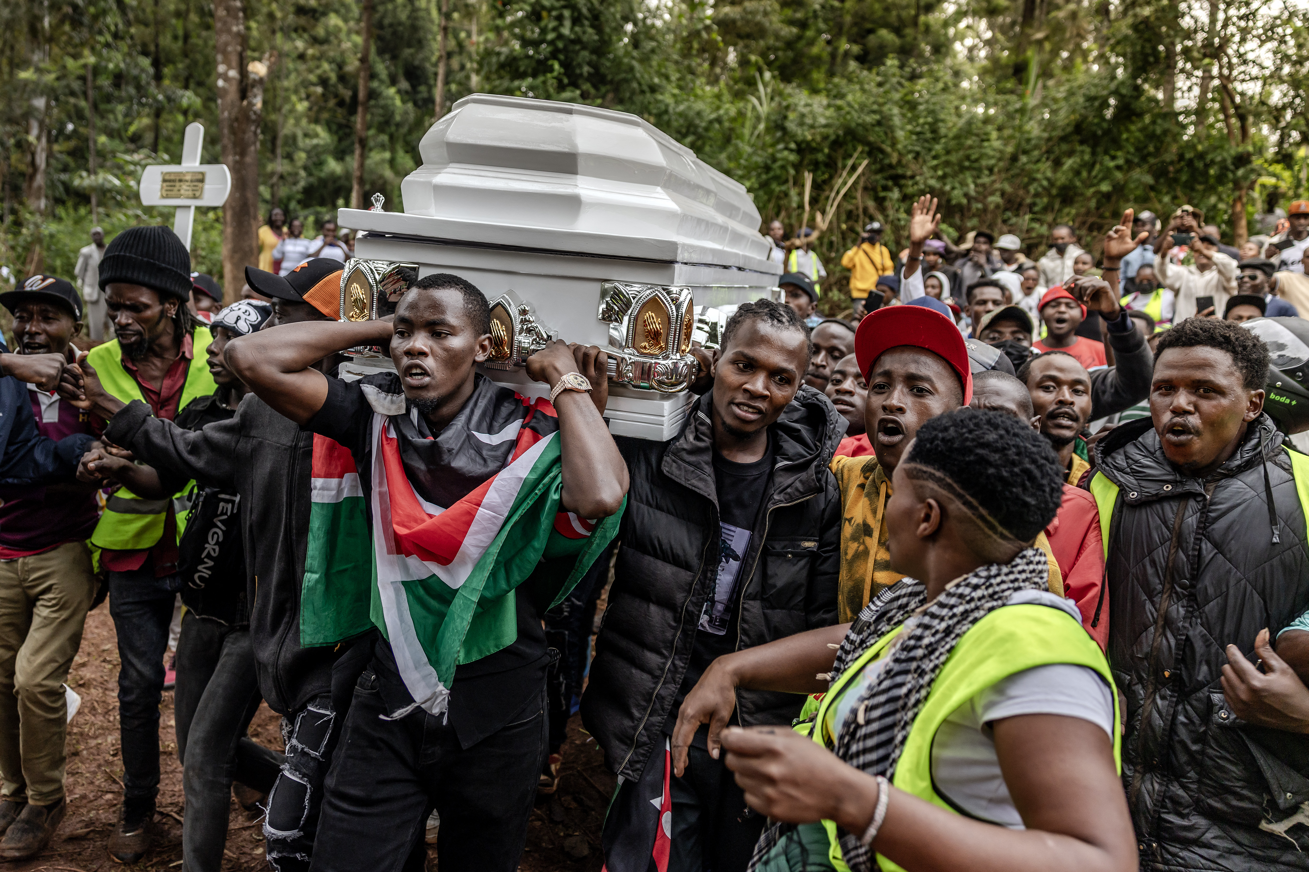 Young Kenyans chant anti-government slogans as they carry the coffin of Boniface Kariuki during his funeral in Kangema, on July 11, 2025