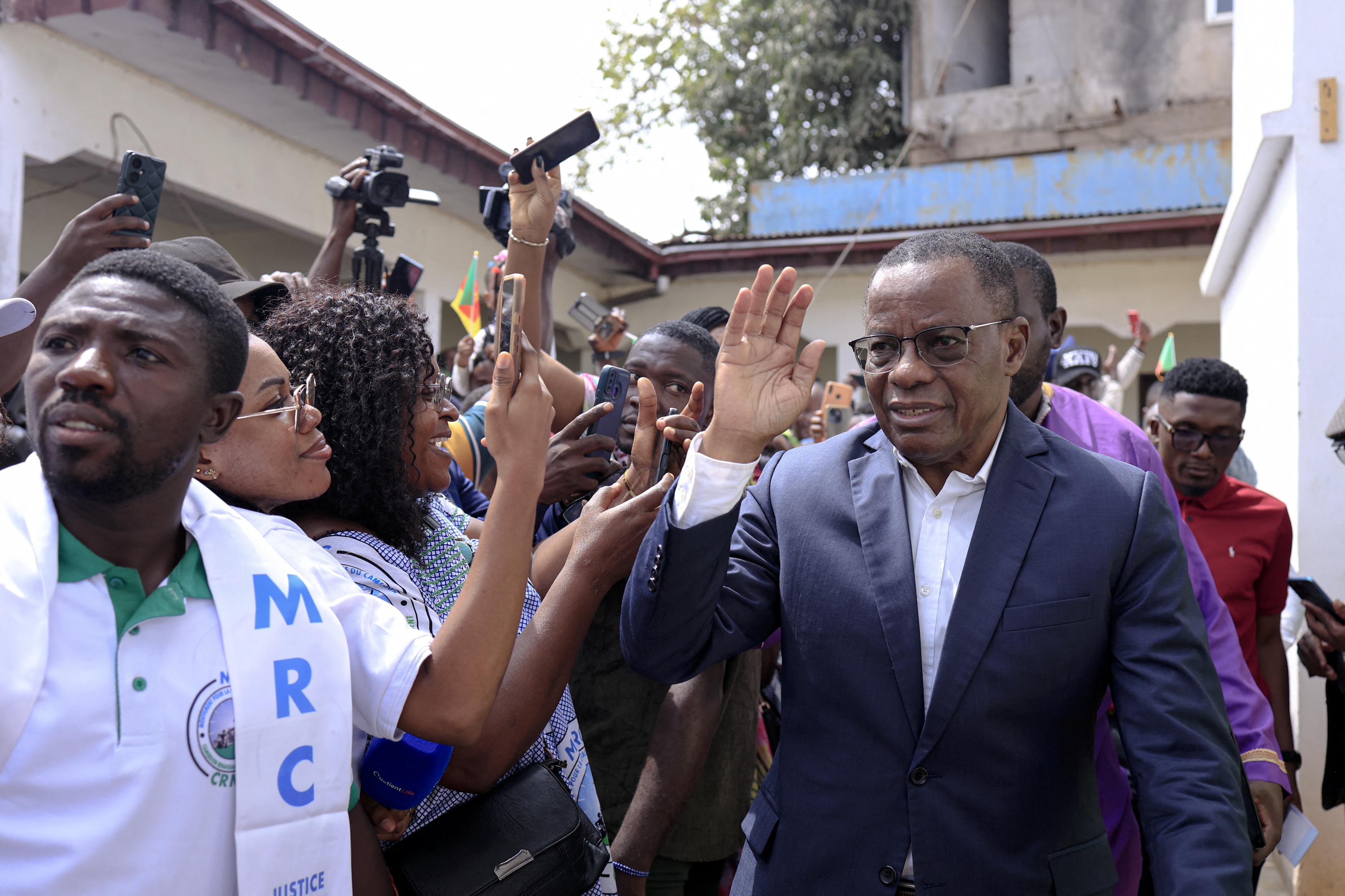 Maurice Kamto (R), newly nominated by African Movement for New Independence and Democracy (MANIDEM) as its presidential candidate, greets supporters after a press conference in Yaounde, Cameroon on July 19, 2025.