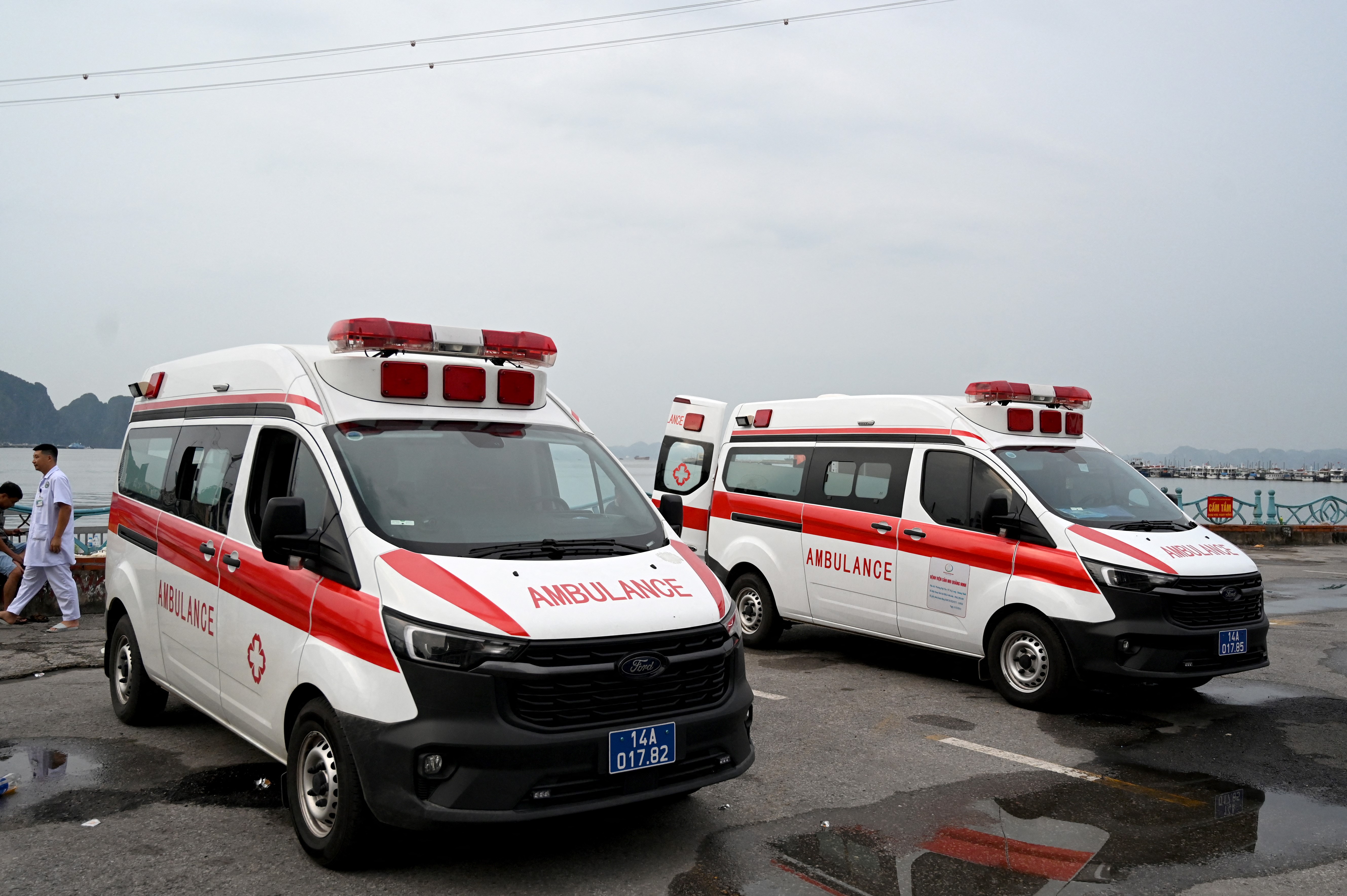 two ambulances parked next to water