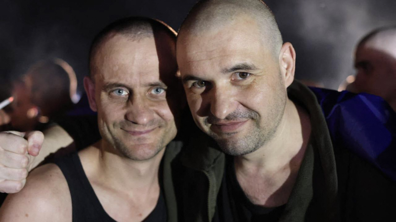 This handout photograph taken and released by the Ukrainian Presidential Press Service on July 23, 2025, shows Ukrainian prisoners of war (POWs) posing for a picture following an exchange of prisoners at an undisclosed location in Ukraine