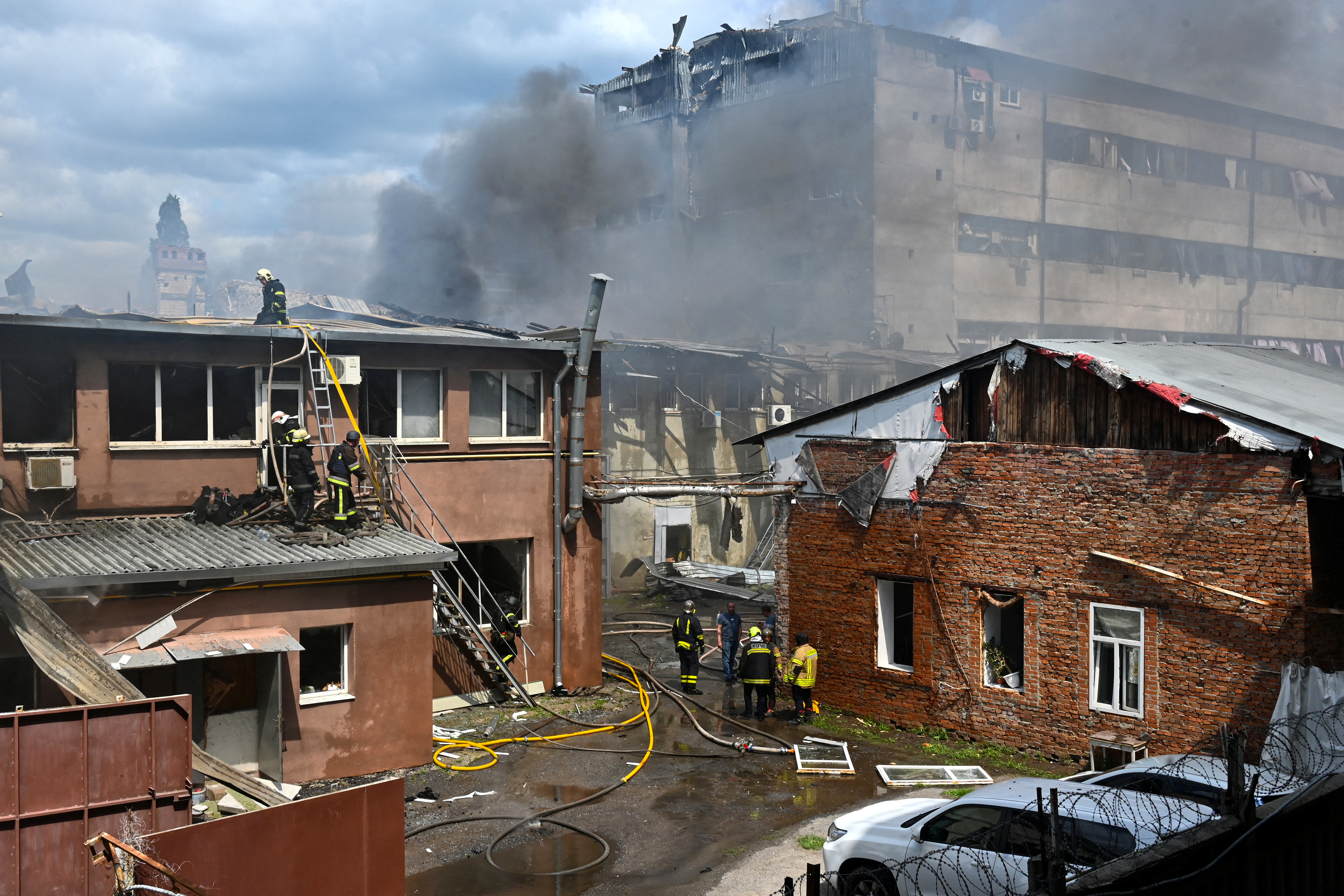 Ukrainian rescuers work to extinguish a fire at the site of an aerial attack in Kharkiv on July 24, 2025, amid the Russian invasion in Ukraine. (Photo by SERGEY BOBOK / AFP)