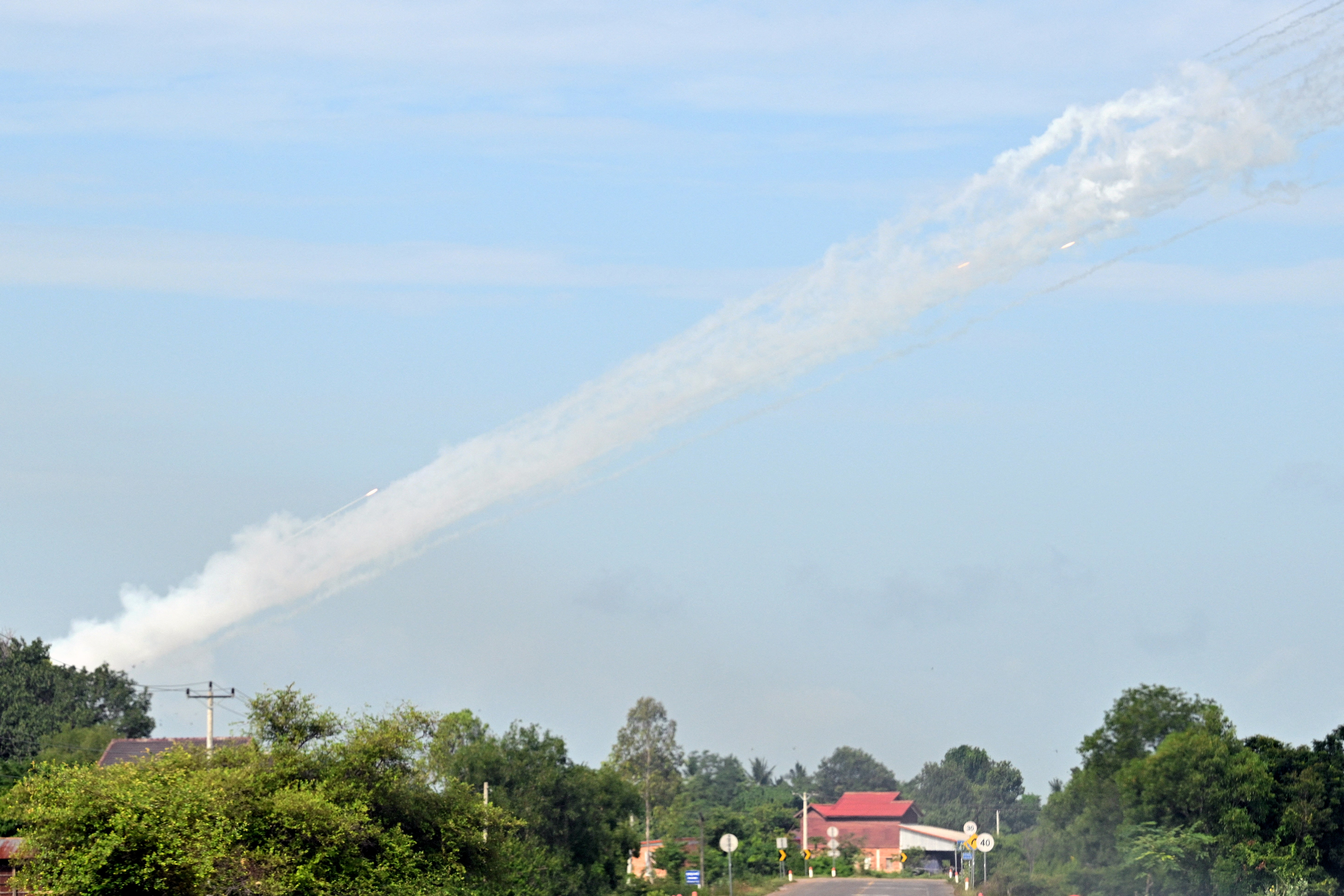 Smoke is pictured in the air as a multi-rocket launcher is fired near the Cambodia-Thailand border in Oddar Meanchey province on July 25, 2025
