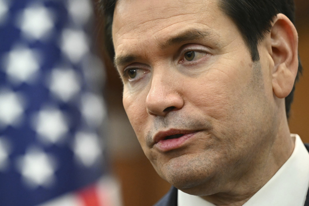 a close up of a man's face in front of an American flag