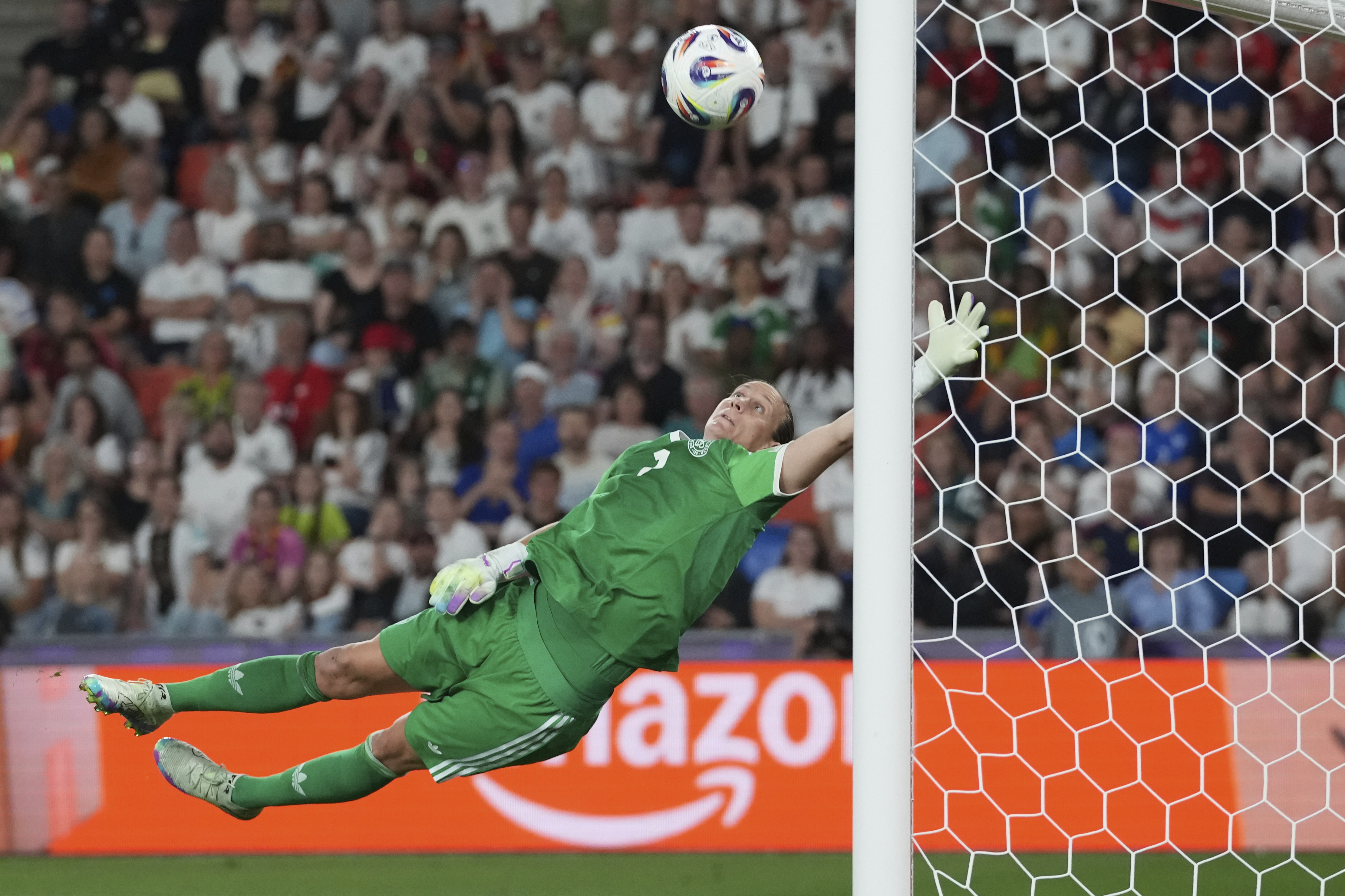 Germany goalkeeper Ann-Katrin Berger leaps to make a save during the Women's Euro 2025 quarterfinals soccer match between France and Germany at St. Jakob-Park in Basel, Switzerland, Saturday, July 19, 2025. (AP Photo/Martin Meissner)