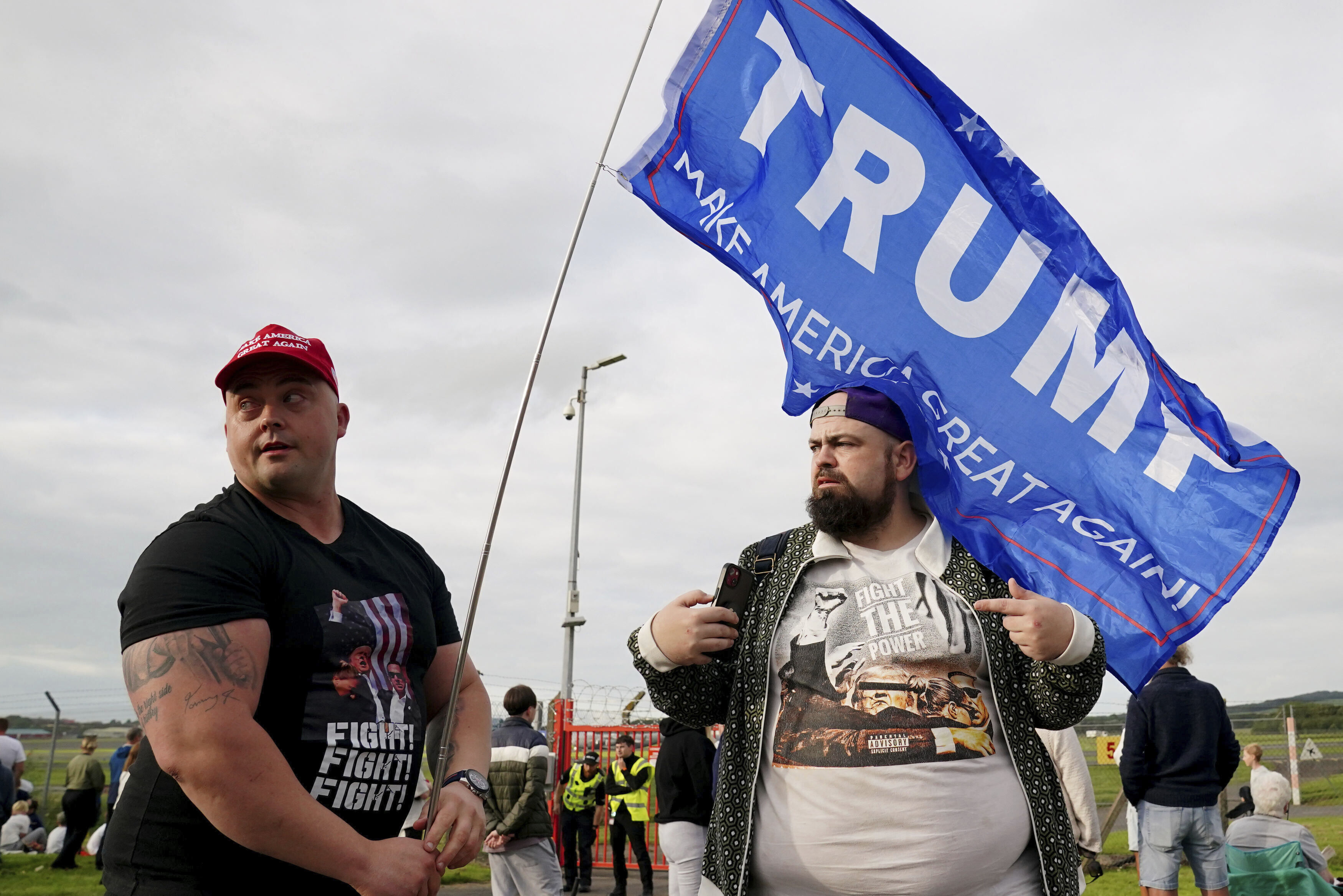 People gather outside the airport before Trump's arrival.