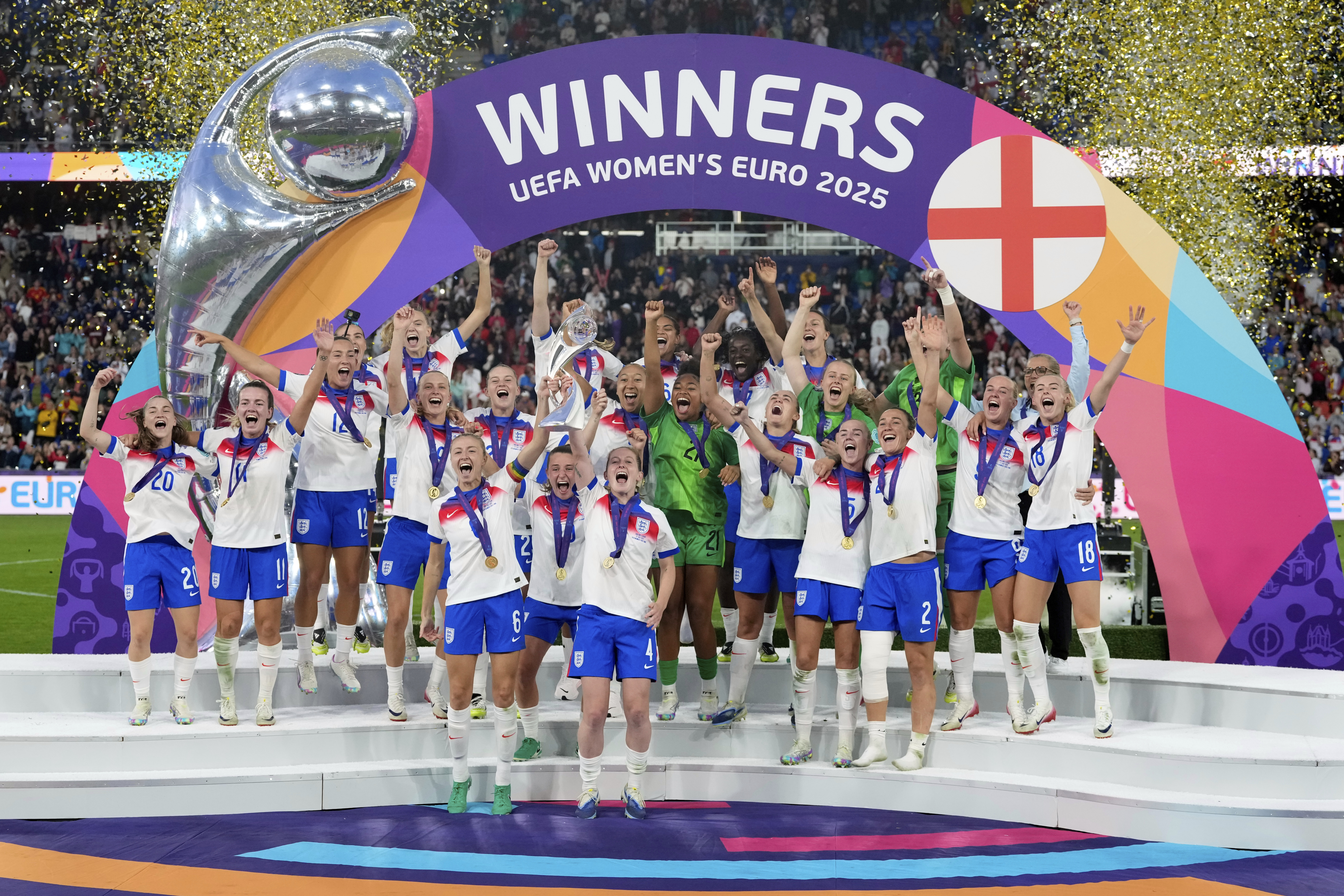England's Leah Williamson, center left, and Keira Walsh lift the trophy after winning the Women's Euro 2025 final soccer match between England and Spain at St. Jakob-Park in Basel, Switzerland, Sunday, July 27, 2025. (AP Photo/Alessandra Tarantino)