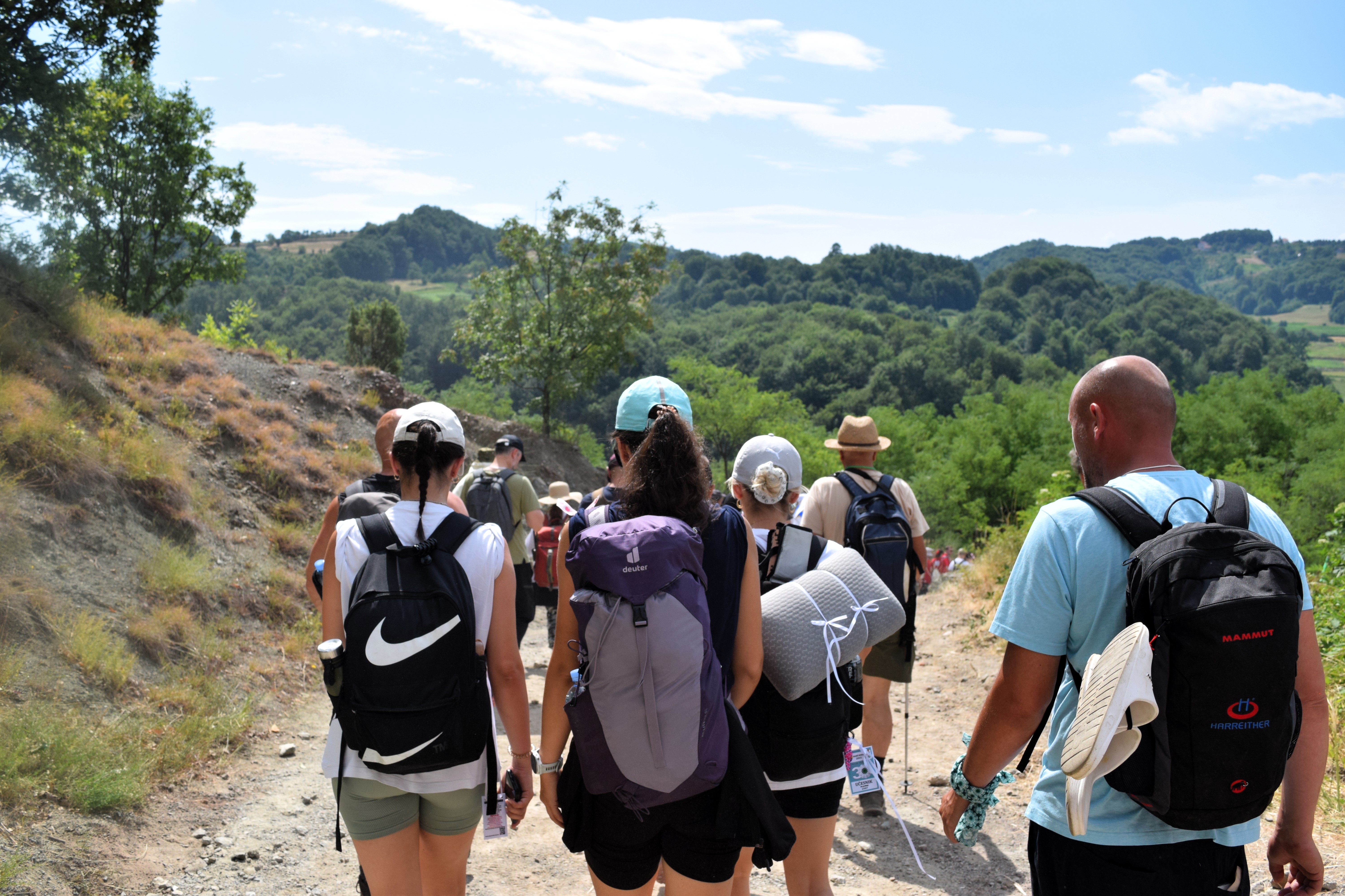 The marchers continued across rolling green hills and stony slopes