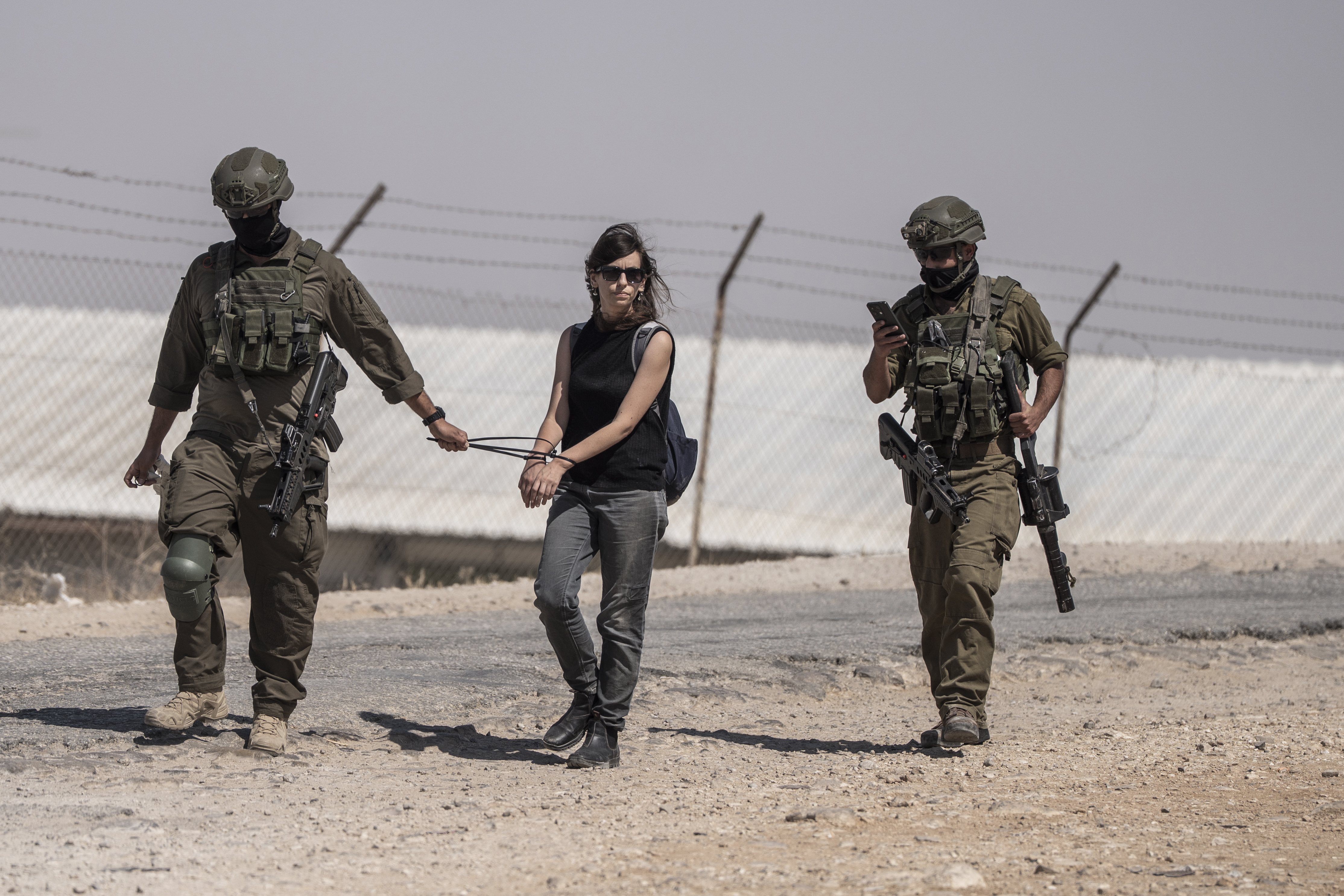 29 July 2025, Palestinian Territories, Hebron: Israeli Defense Forces arrest an activist as they raid the mourning tent where Palestinians of Umm Al-Khair community gatheted to mourn Awdah Al-Hathaleen, who was shot by an Israeli right-wing settler the previous day. Photo: Ilia Yefimovich/dpa (Photo by Ilia Yefimovich/picture alliance via Getty Images)