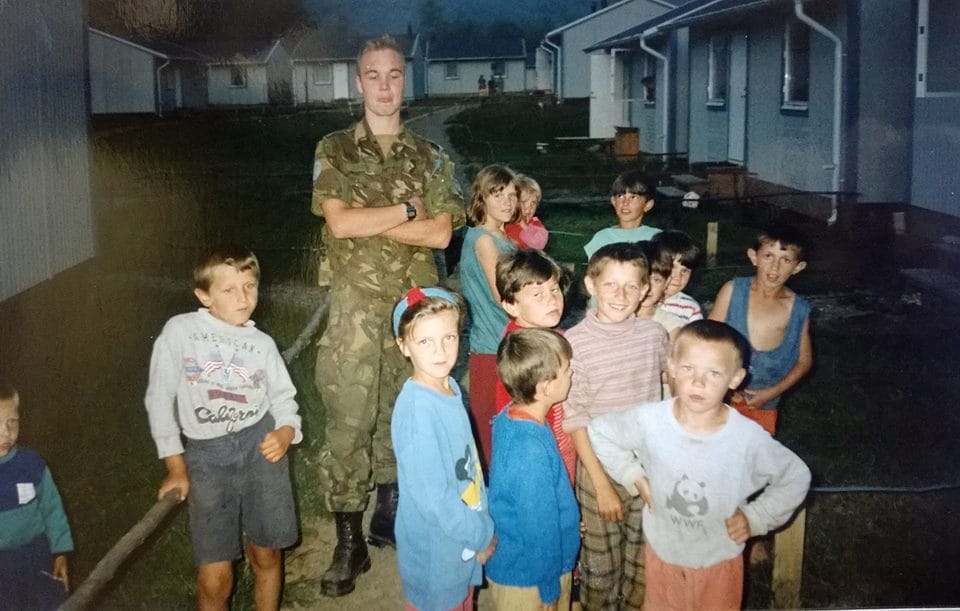 Bosniak refugee children from Srebrenica at a makeshift refugee camp in in Slapovici pose with a Dutch UN soldier, 1994 [Photo courtesy of Nedzad Avdic]