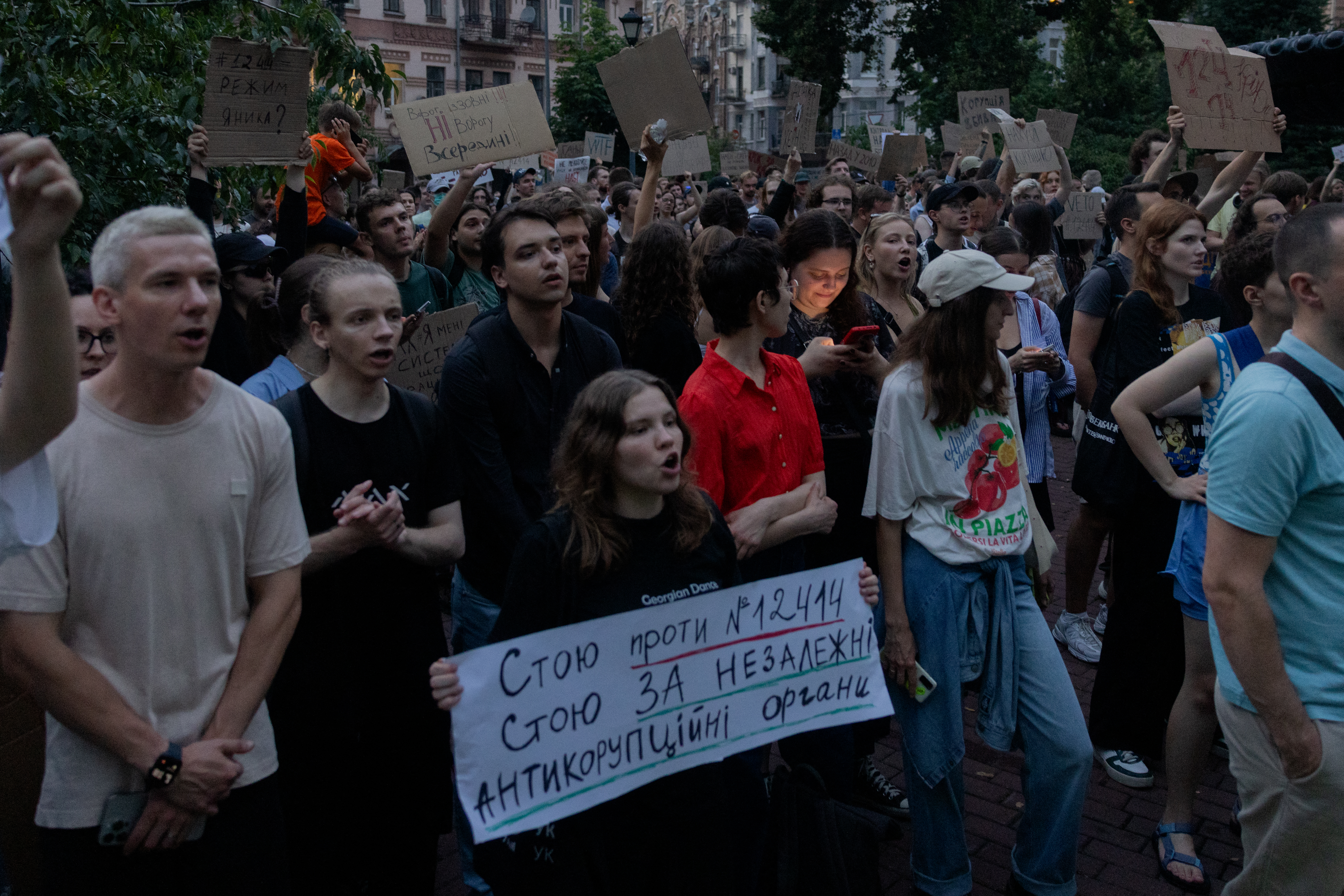 Protesters hold placards during a demonstration calling for the Ukrainian president to veto a law passed by parliament that reduces the powers of Ukraine’s National Anti-Corruption Bureau (NABU) and Specialised Anti-Corruption Prosecutor's Office (SAPO) in downtown Kyiv on July 22, 2025, amid the Russian invasion of Ukraine.