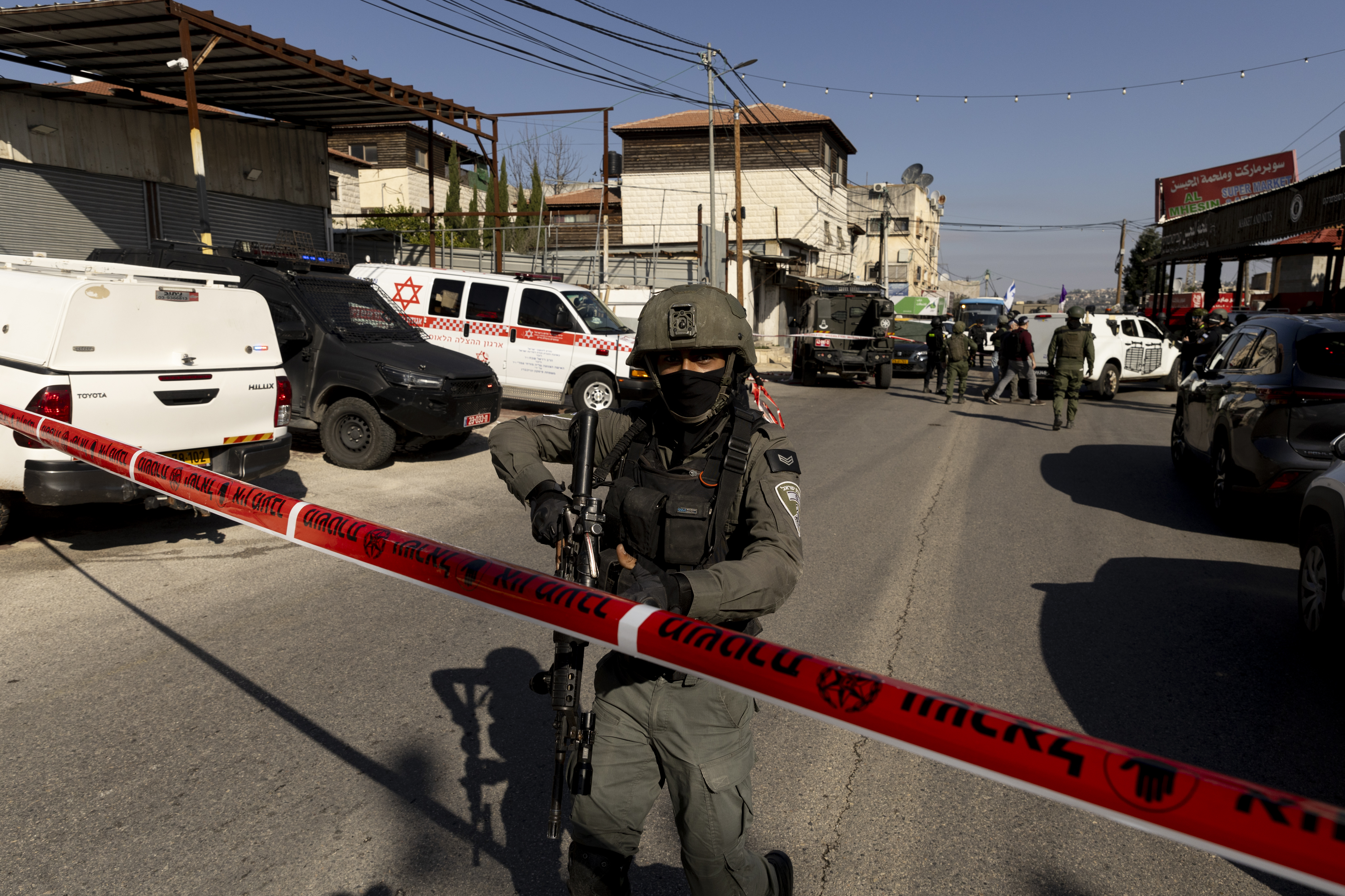 AL FUNDUQ, WEST BANK - JANUARY 6: Israeli soldiers seen following a shooting attack on January 6, 2025 in the Palestinian village of Al-Funduq, West Bank. Three people were reported killed and others injured, and security forces are still searching for the assailants. The site is located between the Israeli West Bank settlements of Karnei Shomron and Kdumim. (Photo by Amir Levy/Getty Images)