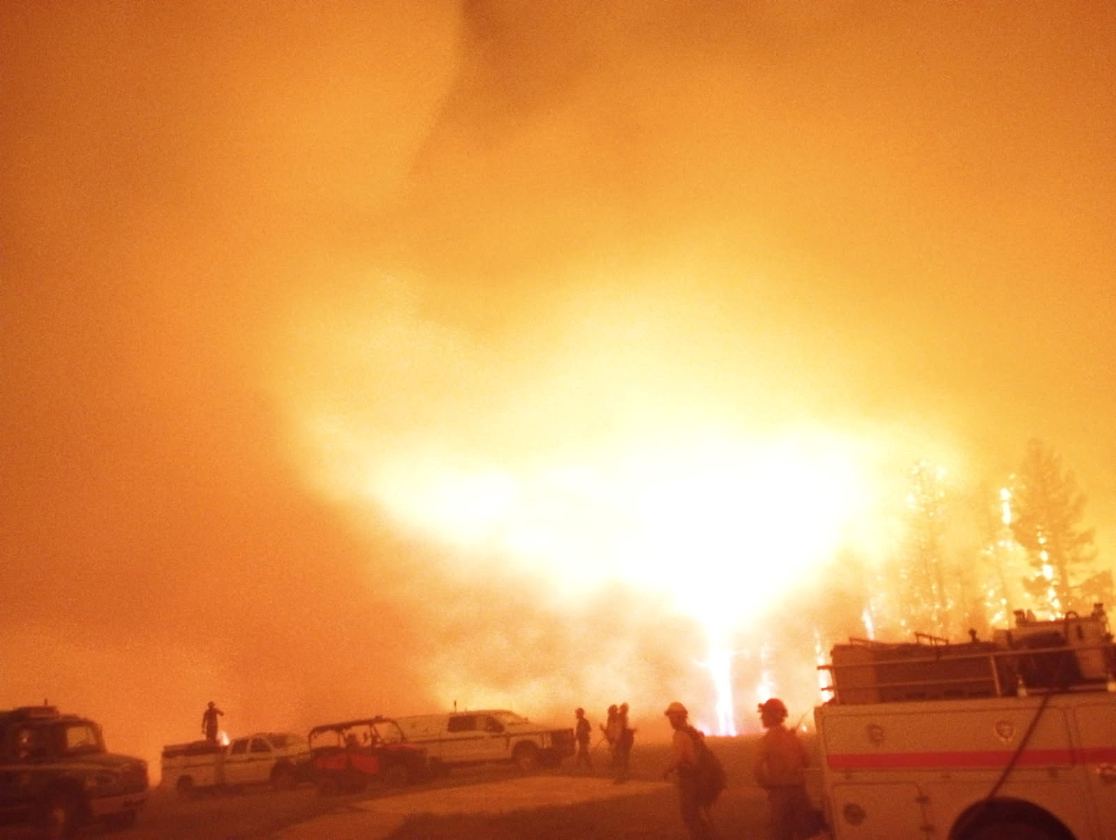 Firefighters and emergency vehicles are positioned in front of the Dragon Bravo Fire in Grand Canyon, Arizona, U.S. in this image released July 13, 2025. National Park Service/Handout via REUTERS THIS IMAGE HAS BEEN SUPPLIED BY A THIRD PARTY. MANDATORY CREDIT.