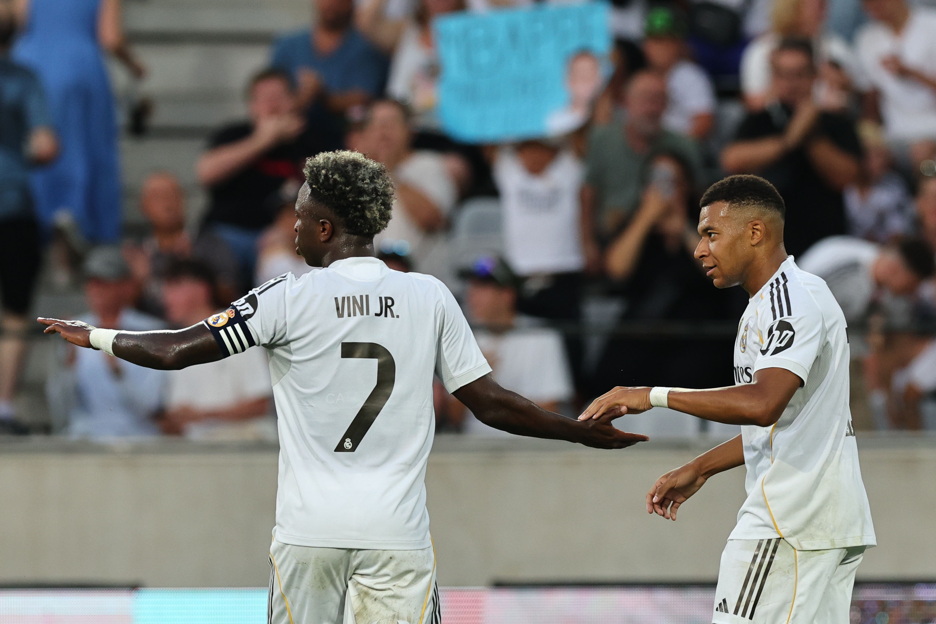 Vinicius Junior and Kylian Mbappe react.