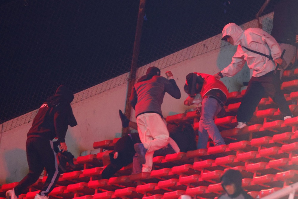 Universidad de Chile fans clash in the stands during the CONMEBOL Copa Sudamericana round of 16 soccer match between Independiente and Universidad de Chile