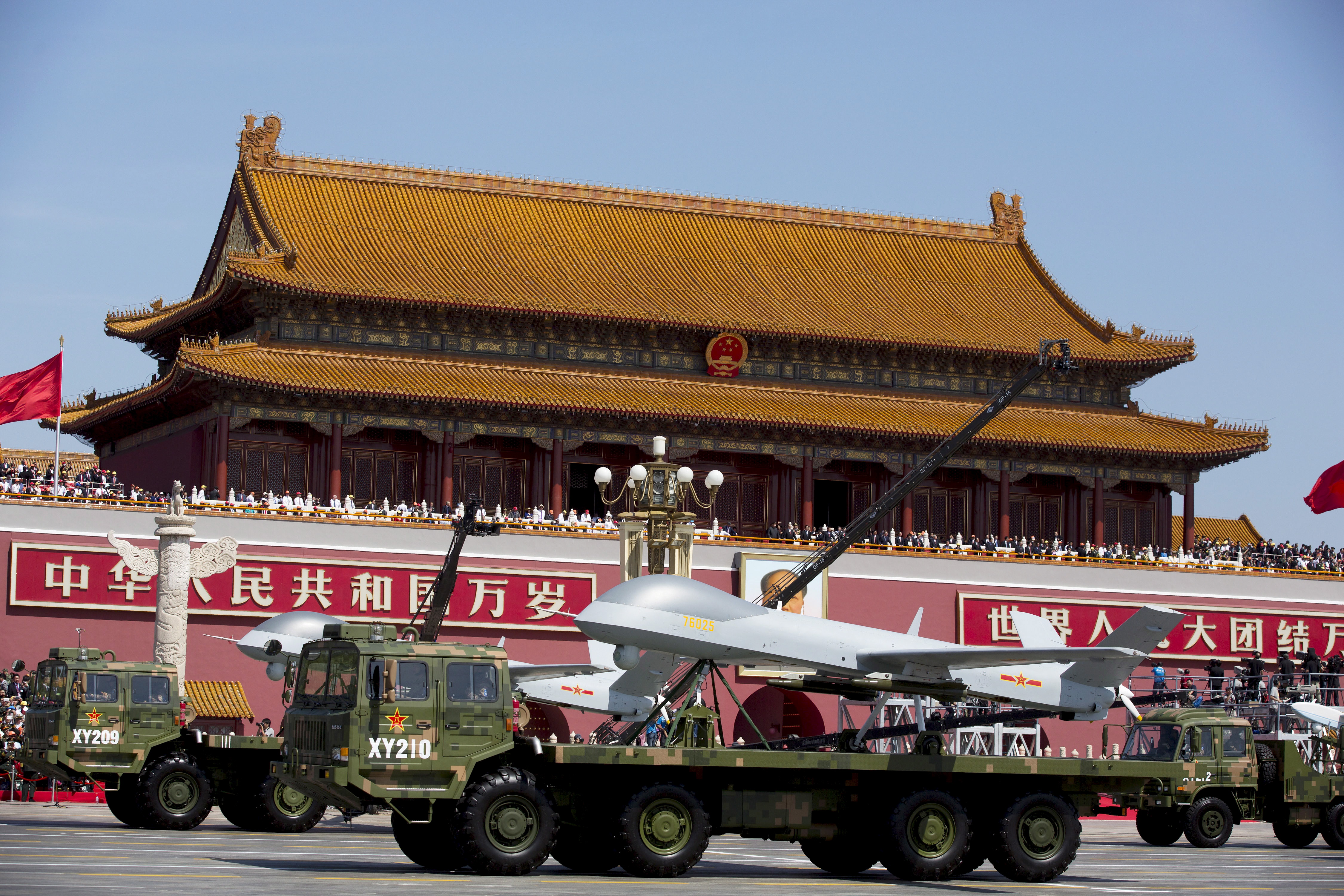 Military vehicles carrying Wing Loong, a Chinese-made medium altitude long endurance unmanned aerial vehicle, travel past Tiananmen Gate during a military parade to commemorate the 70th anniversary of the end of World War II in Beijing Thursday Sept. 3, 2015. REUTERS/Andy Wong/Pool