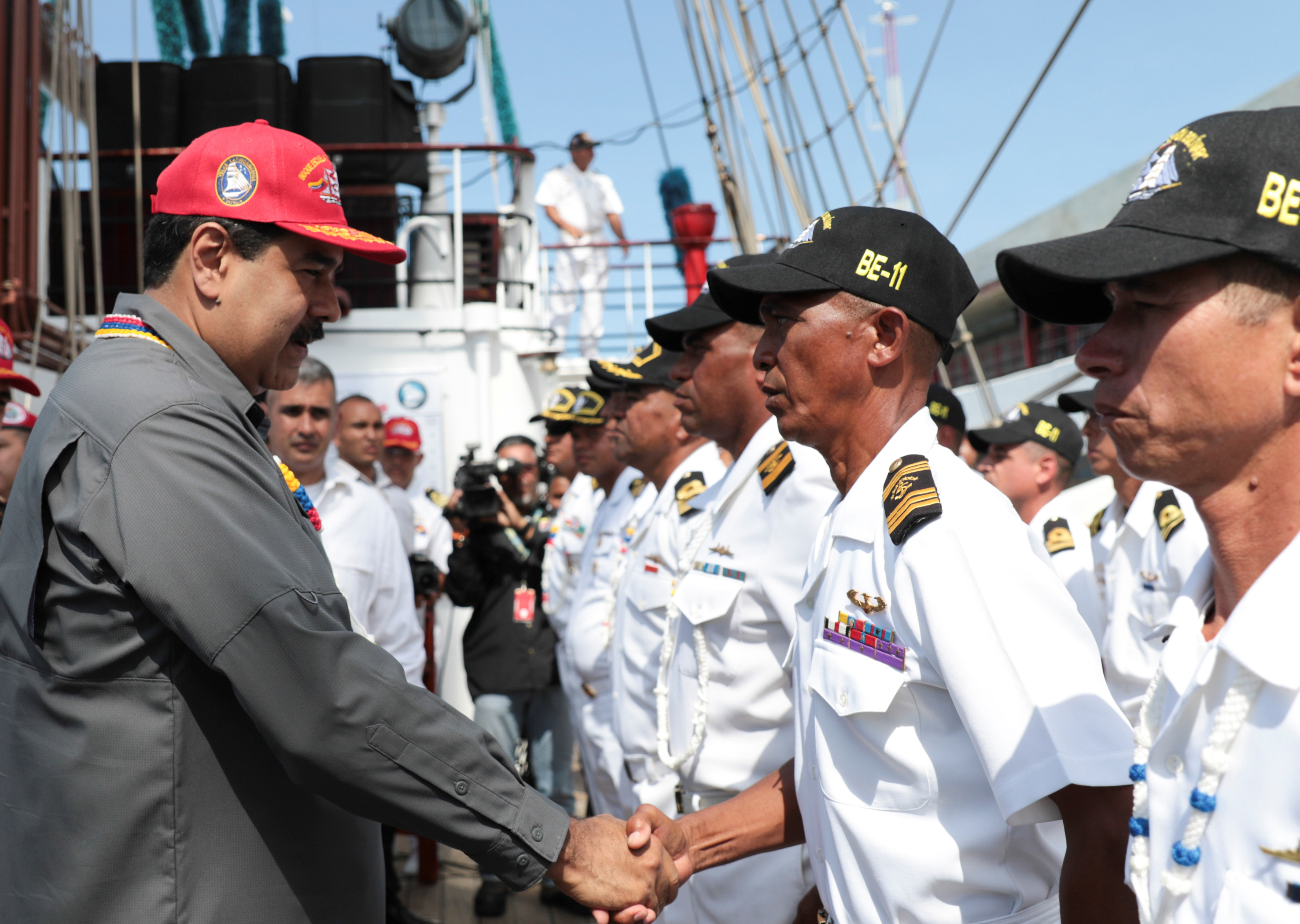 Venezuela's President Nicolas Maduro (L) shakes hands with an officer of the Simon Bolivar training ship, Venezuelan navy's flagship, in La Guaira, Venezuela February 17, 2018. Miraflores Palace/Handout via REUTERS ATTENTION EDITORS - THIS PICTURE WAS PROVIDED BY A THIRD PARTY