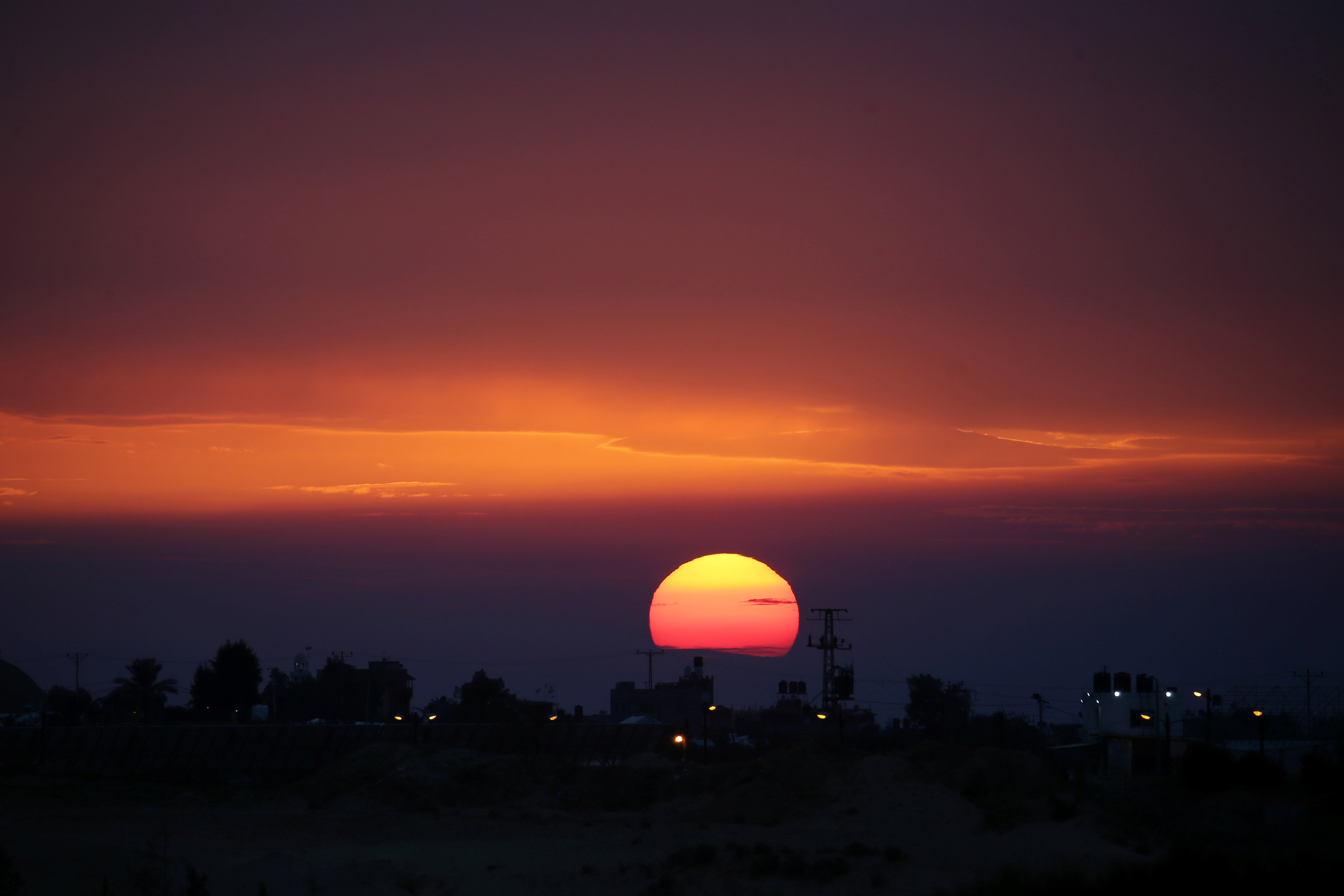 The sun sets over the horizon.