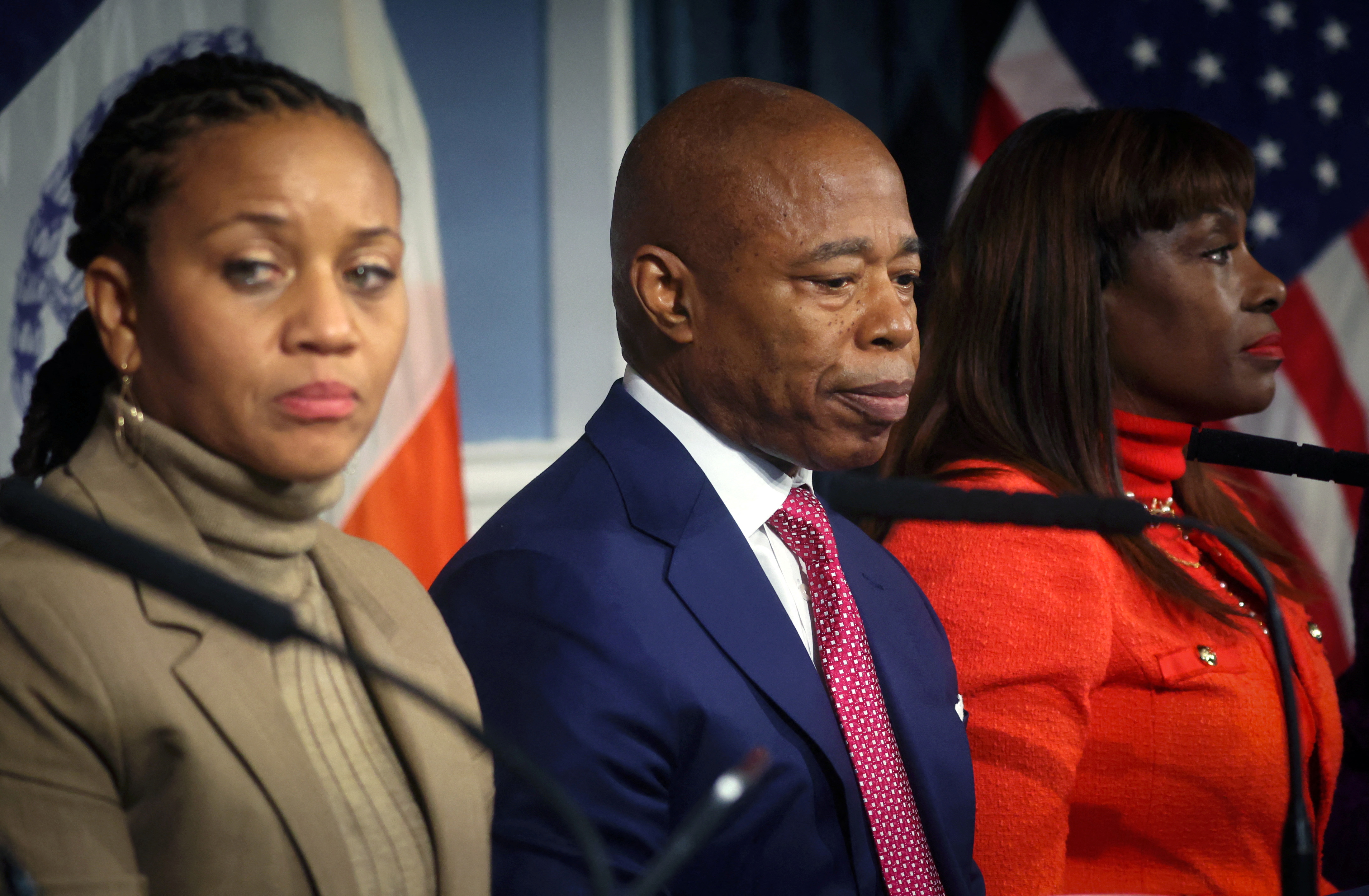 New York City Mayor Eric Adams sits between First Deputy Mayor Sheena Wright, and Chief Advisor Ingrid lewis-Martin, during a press conference 
