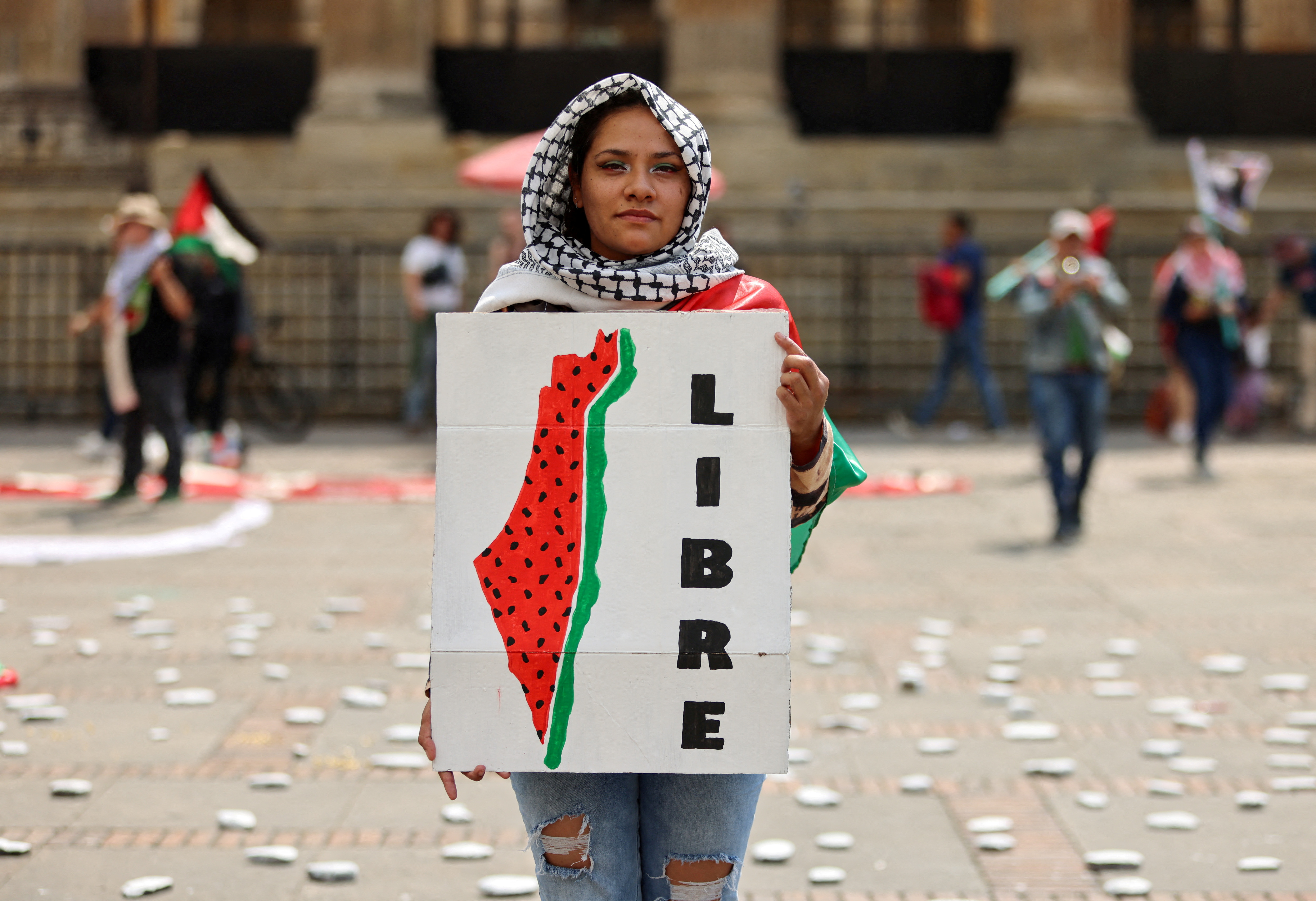 A protester holds a sign during a demonstration demanding an immediate ceasefire in Gaza, as the conflict between Israel and the Palestinian Islamist group Hamas continues, in Bogota, Colombia, January 27, 2024. REUTERS/Luisa Gonzalez TPX IMAGES OF THE DAY