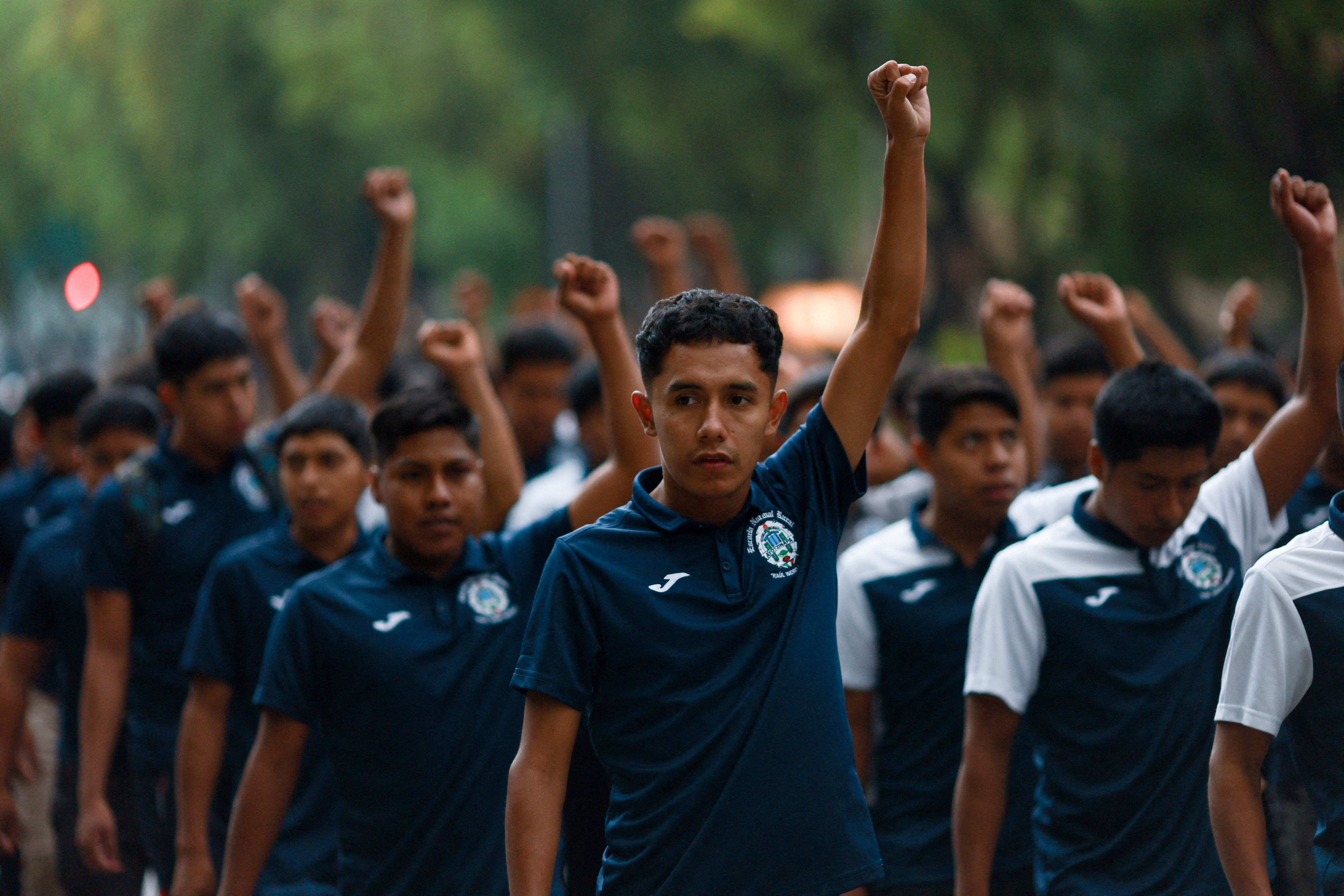 Young men march with their fists in the air